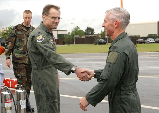 100th Air Refueling Wing Commander Col. Michael S. Stough, left, congratulates Col. Mike Callis, 100th ARW vice commander, following Colonel Callis' final flight at RAF Mildenhall May 10. (U.S. Air Force photo by Staff Sgt. Tyrona Pearsall)