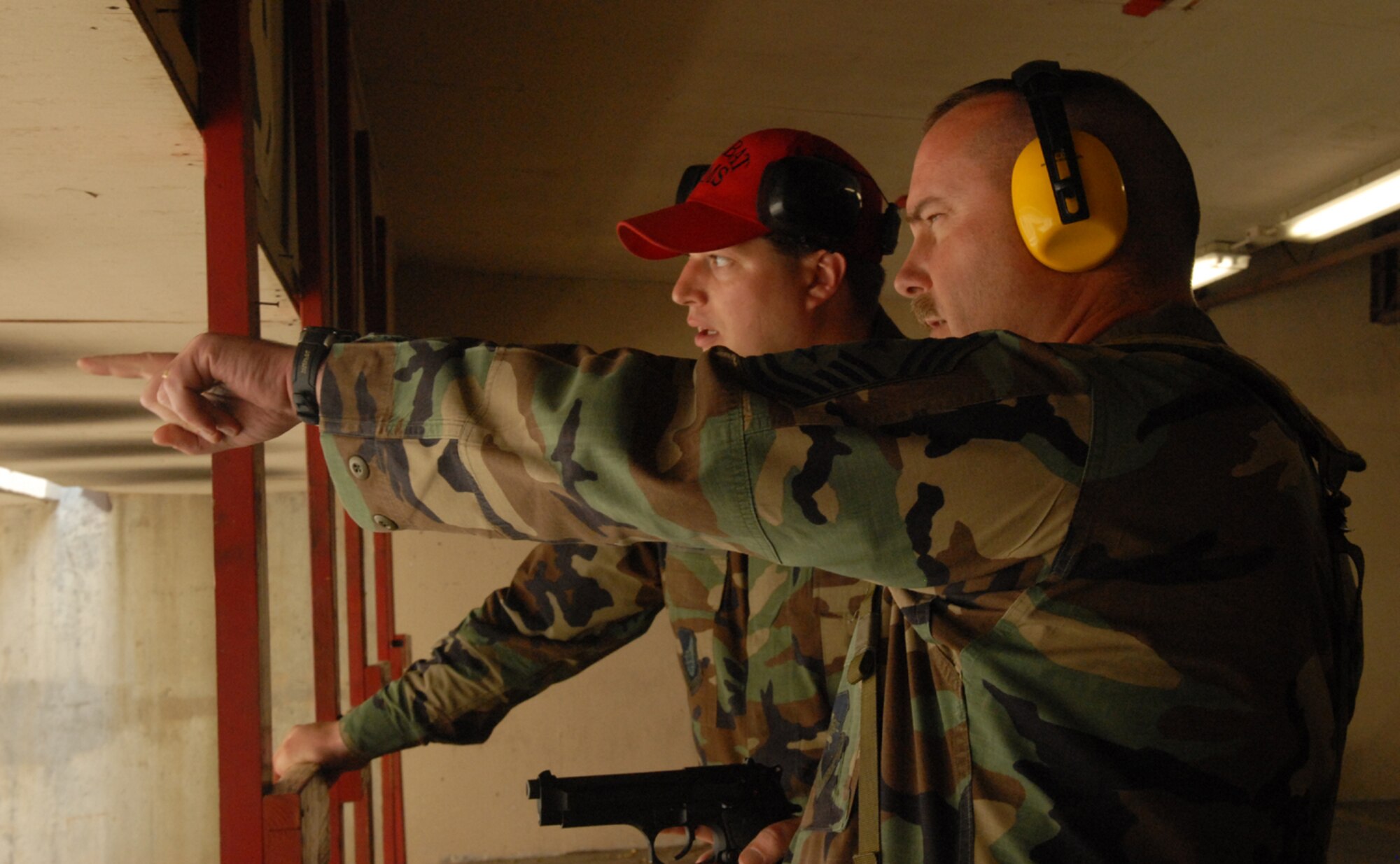 OSAN AIR BASE, Republic of Korea --  Chief Master Sgt. Richard Jette, 51st Fighter Wing command chief master sergeant, discusses the firing range with Tech. Sgt. Jason Seibel, 51st Security Forces Squadron combat arms NCO in charge, during the Commanders & Chiefs Shootout on Tuesday. The winning team was Maj. Frank Schreiber and Senior Master Sgt. Samuel Abernathy, Det 2/18th Intelligence Squadron, with a combined time of 115.24 seconds. The Top Shooter for the day was Lt.Col. Daniel Runyon, 51st Munitions Squadron, with a time of 41 seconds. (U.S. Air Force photo by Senior Airman Eunique Stevens)
