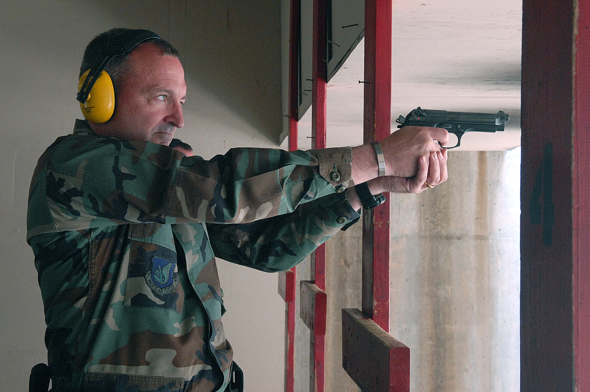 OSAN AIR BASE, Republic of Korea --  Brig. Gen. Joe Reynes, 51st Fighter Wing commander, prepares to fire at the Commanders & Chiefs Shootout on Tuesday. The winning team was Maj. Frank Schreiber and Senior Master Sgt. Samuel Abernathy, Det 2/18th Intelligence Squadron, with a combined time of 115.24 seconds. The Top Shooter for the day was Lt.Col. Daniel Runyon, 51st Munitions Squadron, with a time of 41 seconds. (U.S. Air Force photo by Senior Airman Eunique Stevens)
