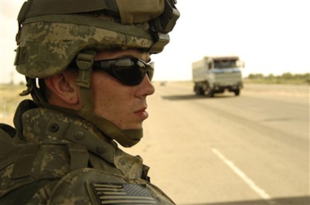 U.S. Army Pfc. Dennis Bailey provides security at a check point on Main Supply Route Tampa in Iraq on May 14, 2007.  Bailey is assigned as a military policeman from the 127th Military Police Company.  
