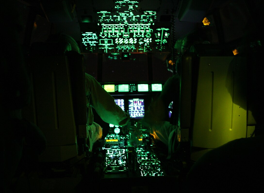 AL ASAD, Iraq - Maj. Chandler Nelms, left, and Capt. Greg Rehlander, both pilots for Marine Aerial Refueling Transport Squadron 252 Detachment A, work the controls for a C-130J "Hercules" during an air delivery mission, May 17.