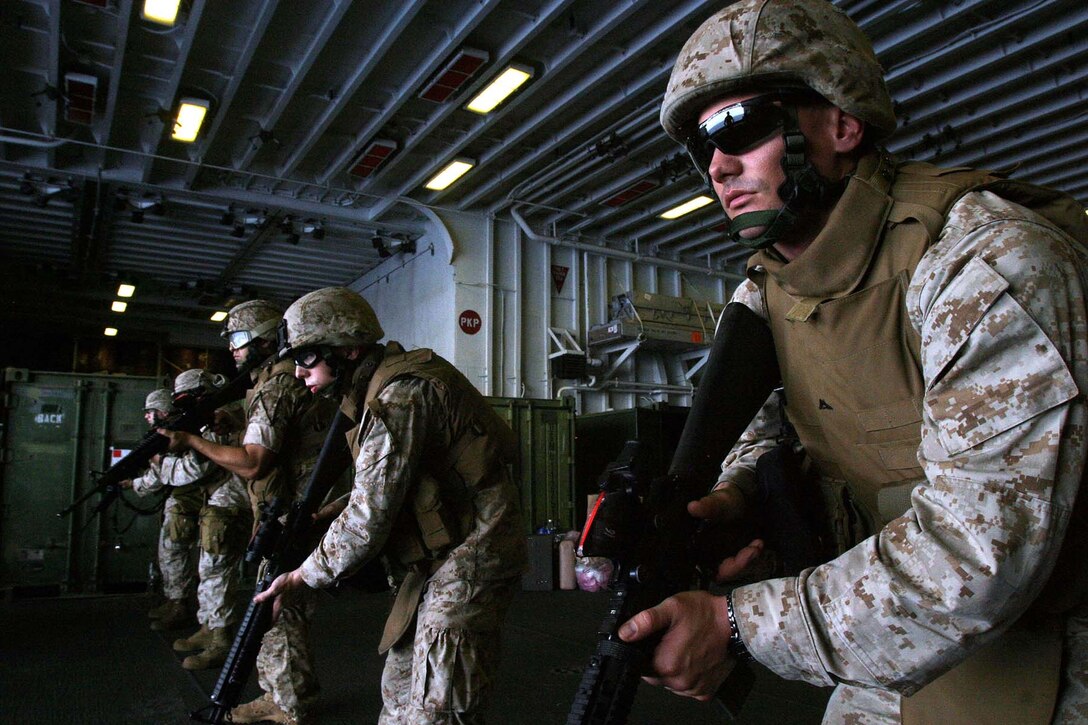 Lance Cpl. Cory L. Burris, a data network specialist from Headquarters and Service Company, Battalion Landing Team 2/2, 26th Marine Expeditionary Unit, and other H&S Co. Marines perform weapons handling drills in the hangar bay aboard USS Bataan (LHD 5), May 17, 2007.  The Marines of BLT 2/2 have had to use creativity and organization to overcome limited training spaces aboard ship.  (Official USMC photo by Cpl. Jeremy Ross) (Released)