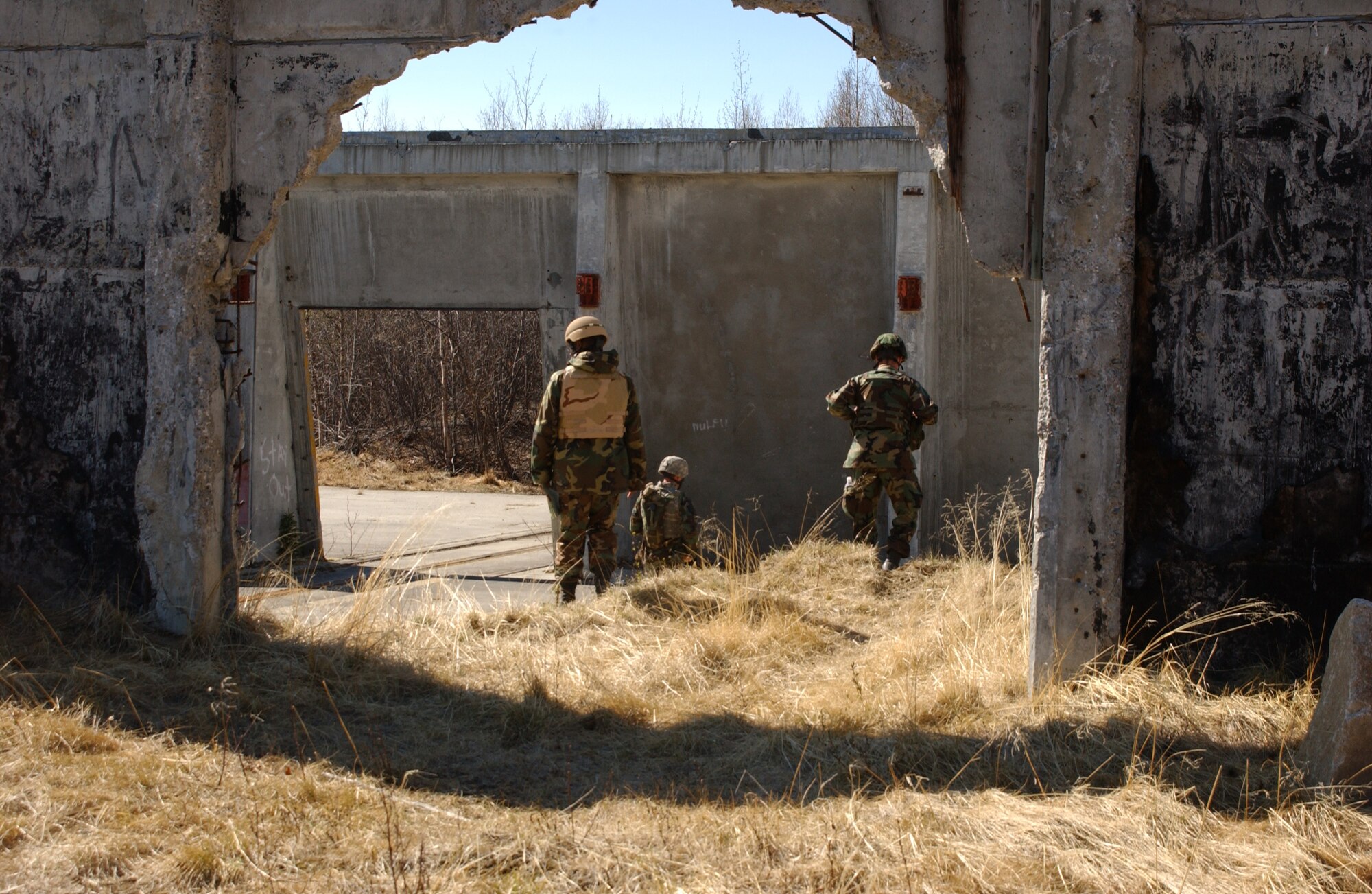 EIELSON AIR FORCE BASE, Alaska -- Capt. Eric Sobecki, Senior Airman John Tranum, and Senior Airman Reynold Black, all of the 3rd Air Support Operations Squadron, find location Kodiak for land navigation exercise during Operation URSA Minor May 16 on the Pacific Alaska Range Complex. Day two of the three-day exercise focuses on navigation skills in unfamiliar territories.  (U.S. Air Force Photo by Airman 1st Class Jonathan Snyder) 