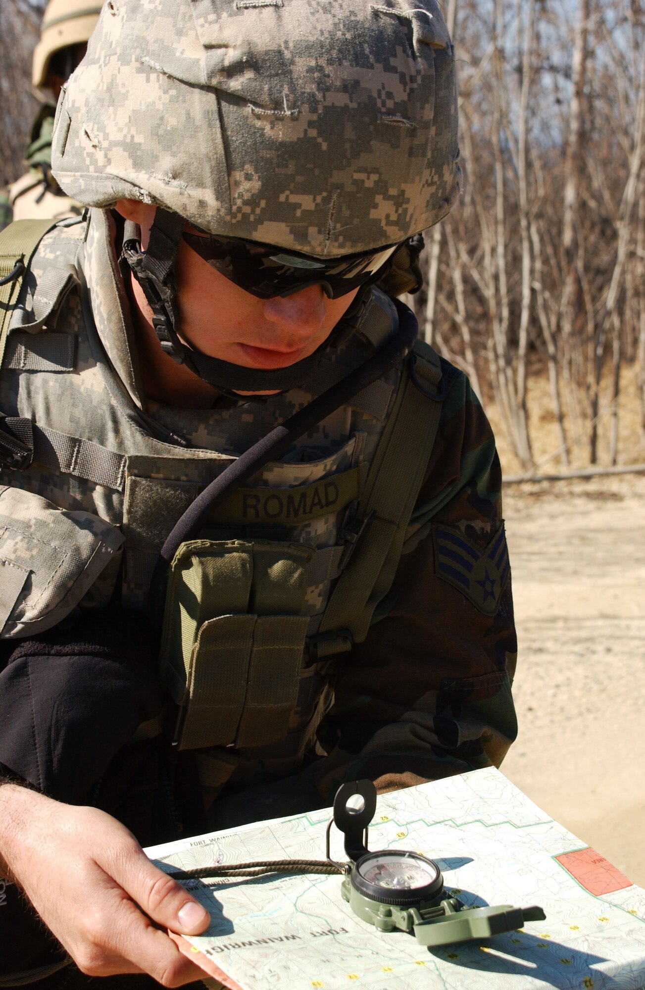 EIELSON AIR FORCE BASE, Alaska -- Senior Airman John Tranum, 3rd Air Support Operations Squadron tactical air control party, uses a map and compass to find location Kodiak for land navigation exercise during Operation URSA Minor May 16 on the Pacific Alaska Range Complex. Day two of the three-day exercise focuses on navigation skills in unfamiliar territories. (U.S. Air Force Photo by Airman 1st Class Jonathan Snyder) 
