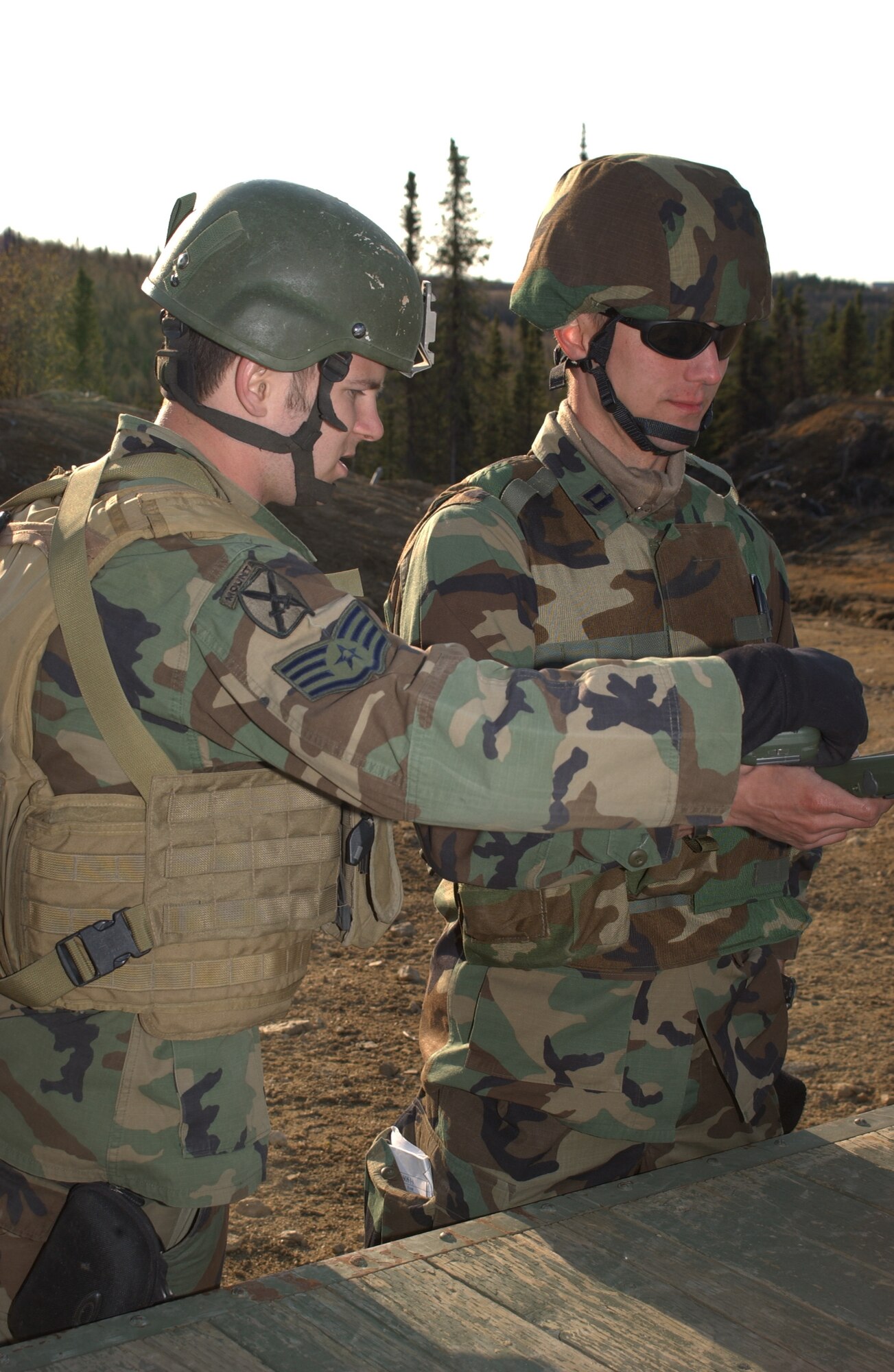 EIELSON AIR FORCE BASE, Alaska --  Tactical Air Control Party members, 3rd Air Support Operations Squadron, Staff Sgt. Peyton Knippel (left), instructs Capt. Eric Sobecki on a PSN-13 Defense Advance GPS receiver. The device is used to find location coordinates during Operation URSA Minor May 16 in the Pacific Alaska Range Complex. The 3rd ASOS trains, equips, and maintains mission-ready air liaison, terminal attack control, and weather observation/forecasting elements to support the U.S. Army Alaska 1st Stryker Brigade Combat Team. (U.S. Air Force Photo by Airman 1st Class Jonathan Snyder) (Released)Observation/Forecasting elements to support the U.S. Army Alaska 1st Stryker Brigade Combat Team. Both are assigned to the 3rd Air Support Operations Squadron, Tactical Air Control Party, Fort Wainwright, AK. (U.S. Air Force Photo by Airman 1st Class Jonathan Snyder) 