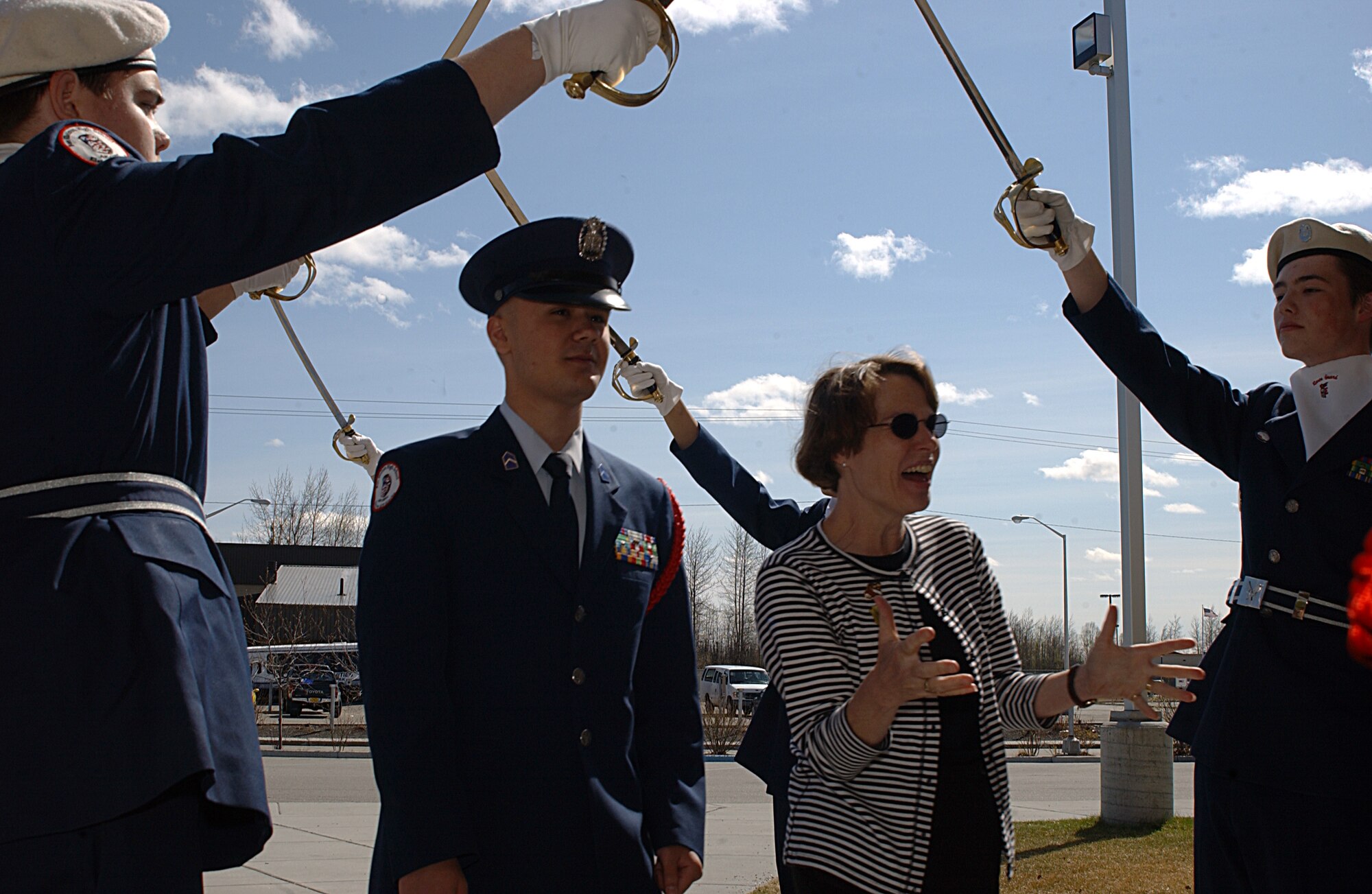 EIELSON AIR FORCE BASE, Alaska -- Cadet Sam Murphy, Ben Eielson High School Junior Reserve Officers Training Corps, escorts Vicki Carlson, spouse of Gen. Bruce Carlson, Air Force Materiel Command commander, Wright-Patterson AFB, Ohio, under the saber arch May 14. This is General Carlson's first stop touring Pacific Air Forces to help gain base familiarization. (U.S. Air Force Photo by Airman 1st Class Jonathan Snyder) 