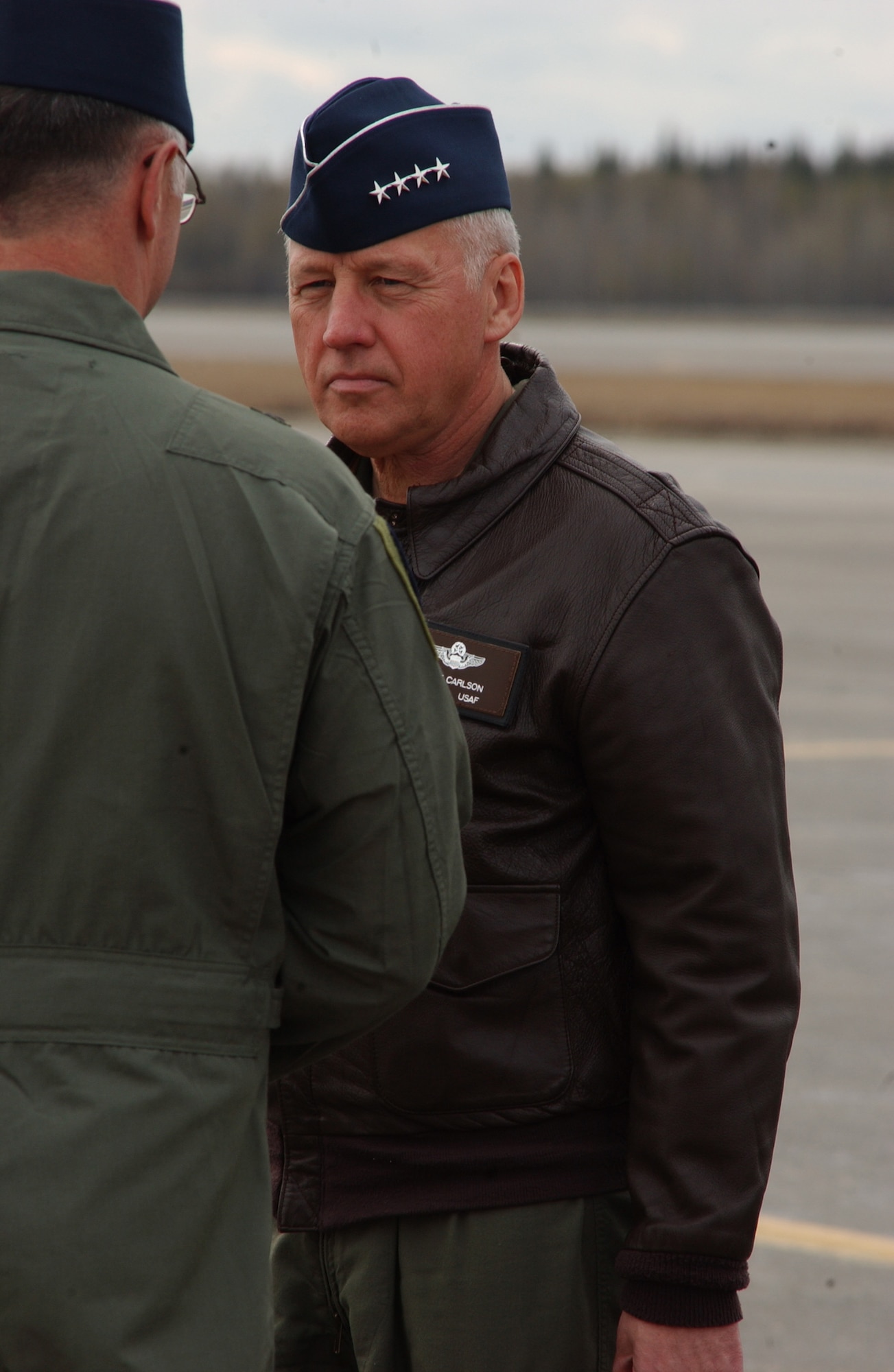 EIELSON AIR FORCE BASE, Alaska -- Gen. Bruce Carlson, Air Force Material Command commander, Wright-Patterson AFB, Ohio, speaks with Brig. Gen. David Scott, 354th Fighter Wing commander May 13. This is General Carlson's first stop touring Pacific Air Forces to help gain base familairization. (U.S. Air Force Photo by Airman 1st Class Jonathan Snyder) 