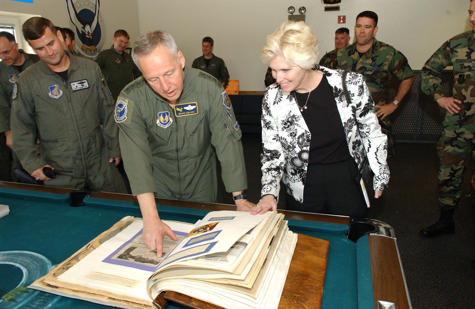 EIELSON AIR FORCE BASE, Alaska --Gen. Bruce Carlson, Air Force Material Command commander, Wright-Patterson AFB, Ohio, looks through a scrap book with Vicki Carlson and members of the 355th Fighter Squadron on May 14th. Gen. Carlson was at one time a member of the 355th Fighter Squadron and as he flipped through the scrap book told stories about people and events he had recognized, Eielson is one of many stops the General will make through the Pacific Air Forces.  (U.S. Air Force photo by Airman 1st Class Christopher Griffin)