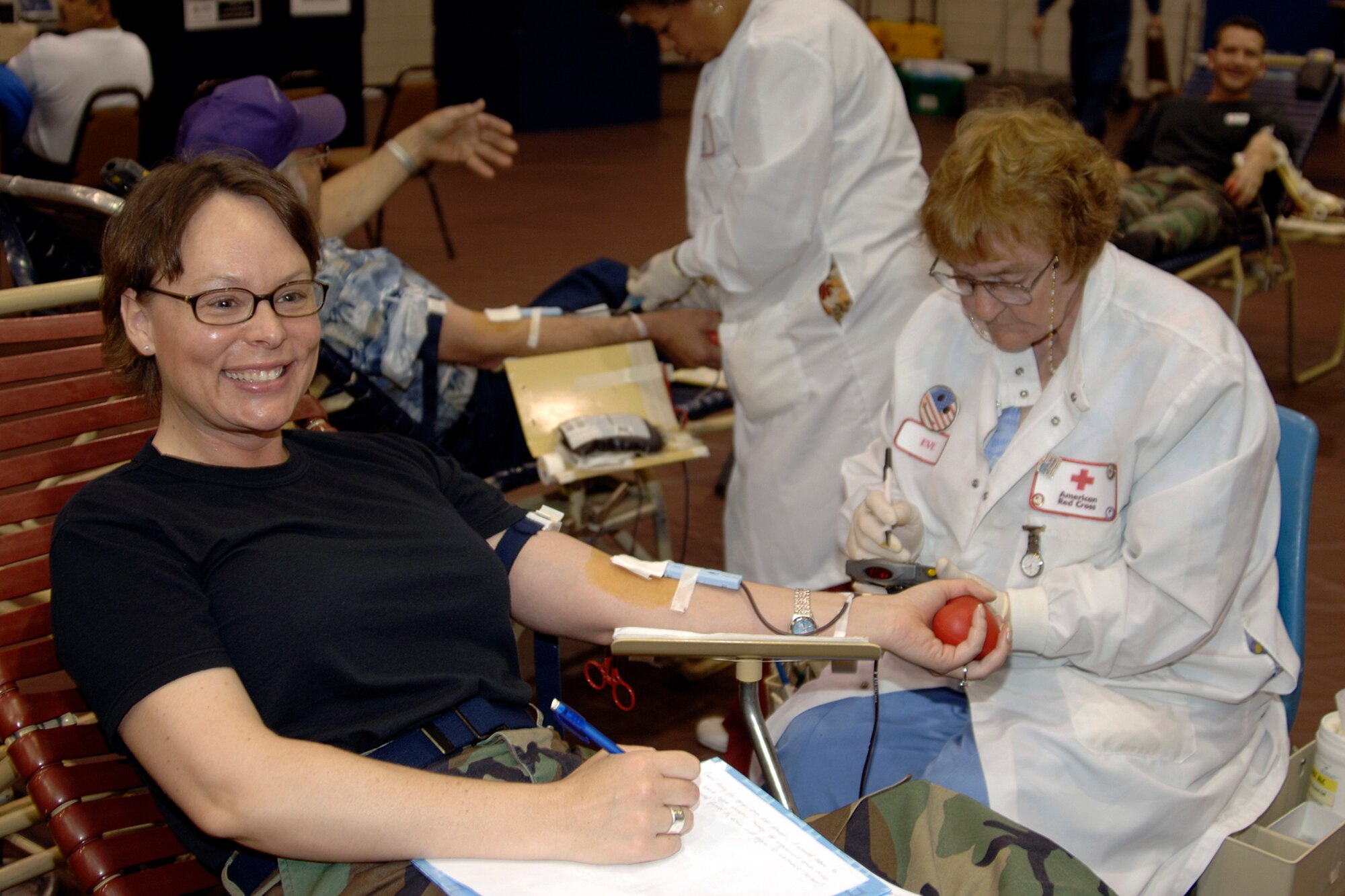 Eve Wenman, a phlebotomist from a local chapter of the American Red Cross, draws blood from Tech. Sgt. Deborah Carr, 22nd Air Refueling Wing military equal opportunity office, May 11 during a blood drive in the fitness center gymnasium. (Photo by Senior Airman Jamie Train)