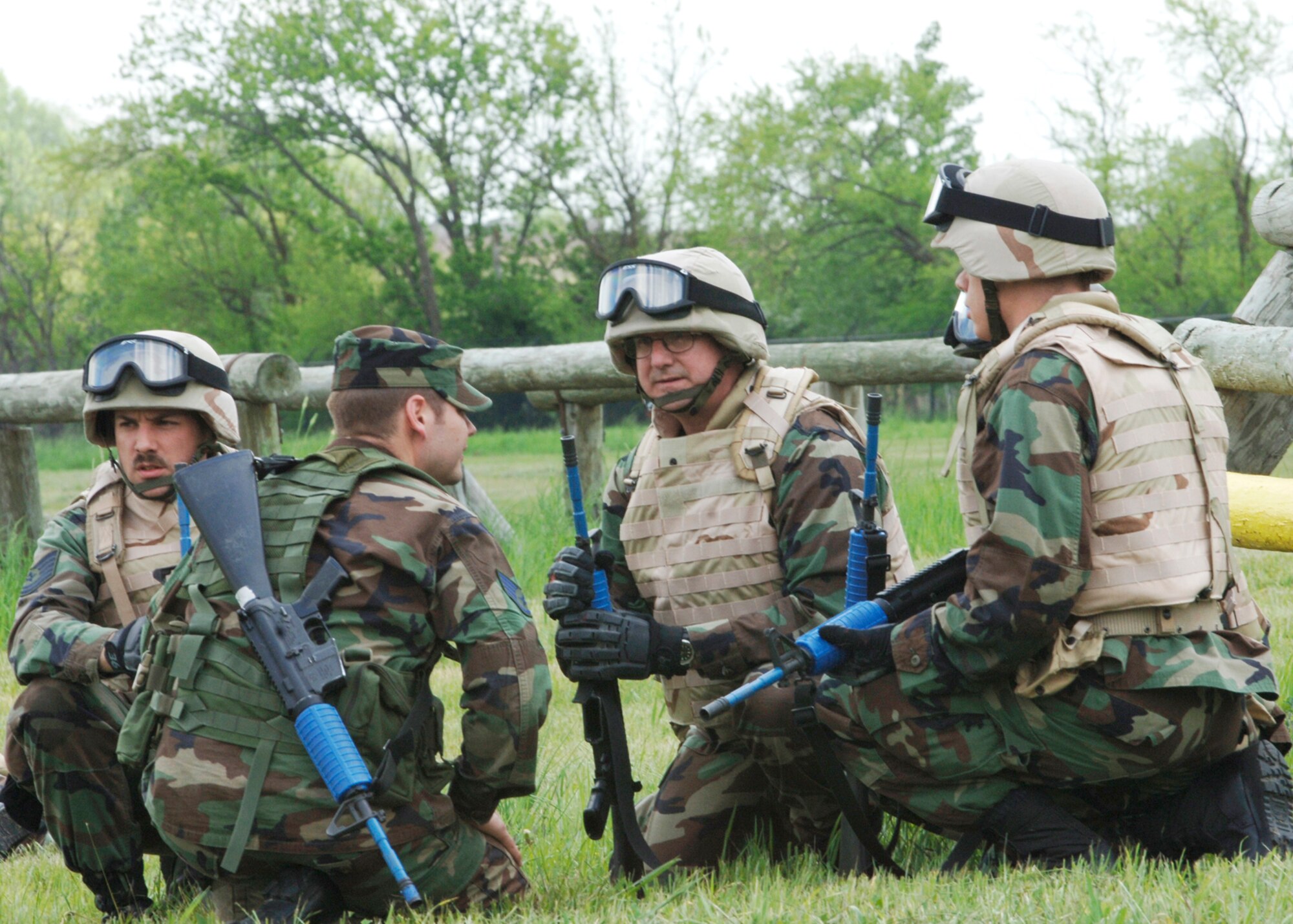 Col. Donald Halpin, 22nd Air Refueling Wing commander, discusses the task plan with Staff Sergeant Sean Gray, 22nd Security Forces Squadron training instructor and two fire team leaders, Tech. Sgt. Brian Denis, 22nd Air Maintenance Squadron, and 2nd Lt. Benjamin Chapman, 22nd Maintenance Operations Squadron, during the field training portion of the Combat Skills Training course near the base obstacle course May 11. (Photo by Airman Justin Shelton)