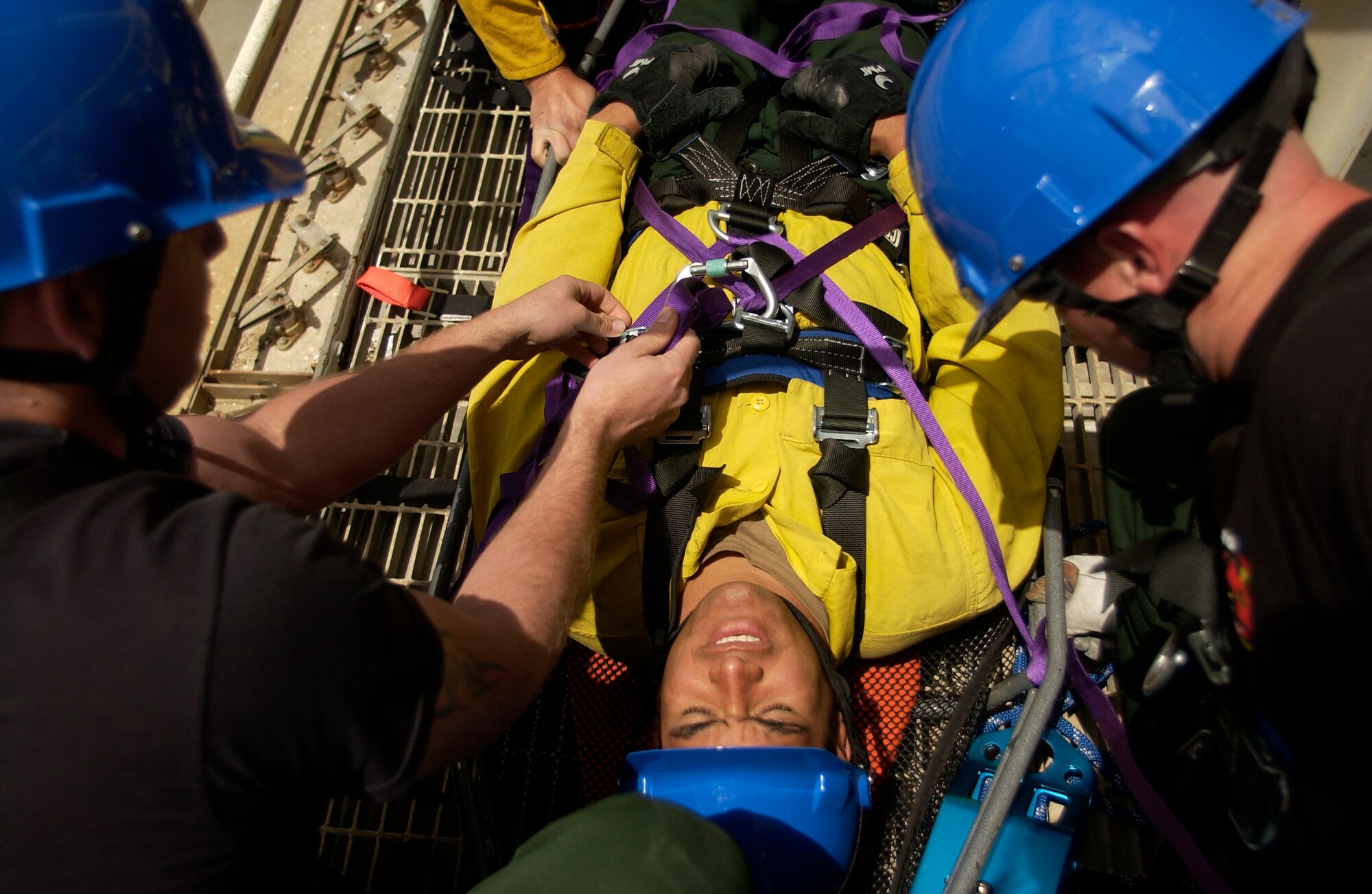 Rescue Technician course students tie a stretcher to Staff Sgt. Kaohilii Romualdo, 30th Civil Engineer Squadron, Fire and Emergency Services flight at Space Launch Complex-4 at Vandenberg Air Force Base May 11. The course helps familiarize the 30th Civil Engineer Squadron firefighter students with advanced rescue techniques. (U.S. Air Force photo by Senior Airman Kristi Emler)
