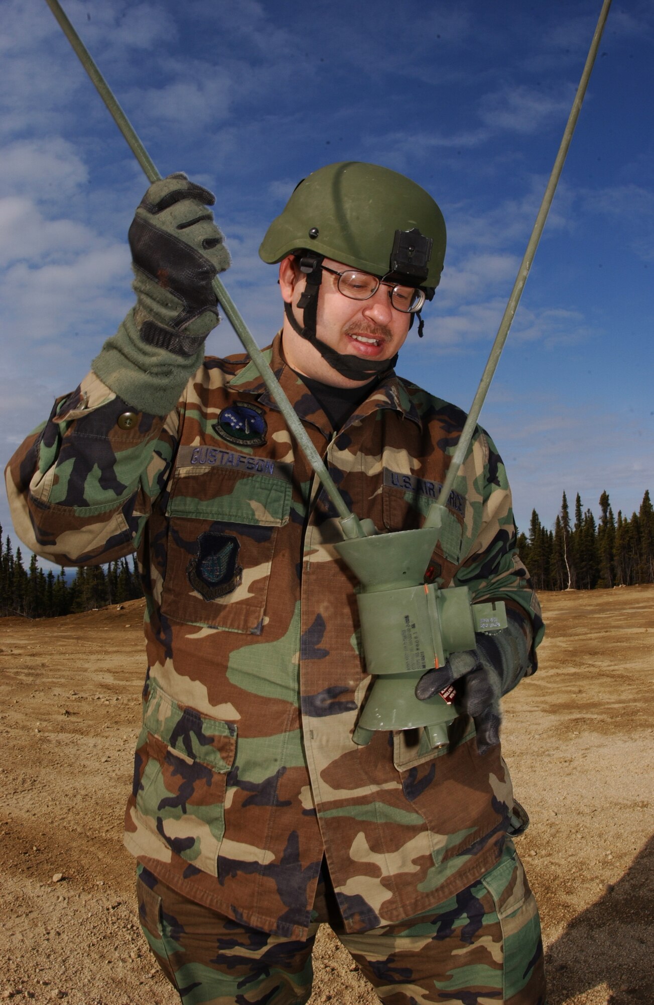 EIELSON AIR FORCE BASE, Alaska -- Staff Sgt. Richard Gustafson, 3rd Air Support Operations Squadron, screws rods into a an OE-254 FM Radio Antenna to enable communication with Army personnel May 15 during Operation URSA Minor. ASOS members completed day one of a three-day field training exercise designed to prepare Airman with hands on combat training and experience before deploying to a combat area. (U.S. Air Force Photo by Airman 1st Class Jonathan Snyder) 