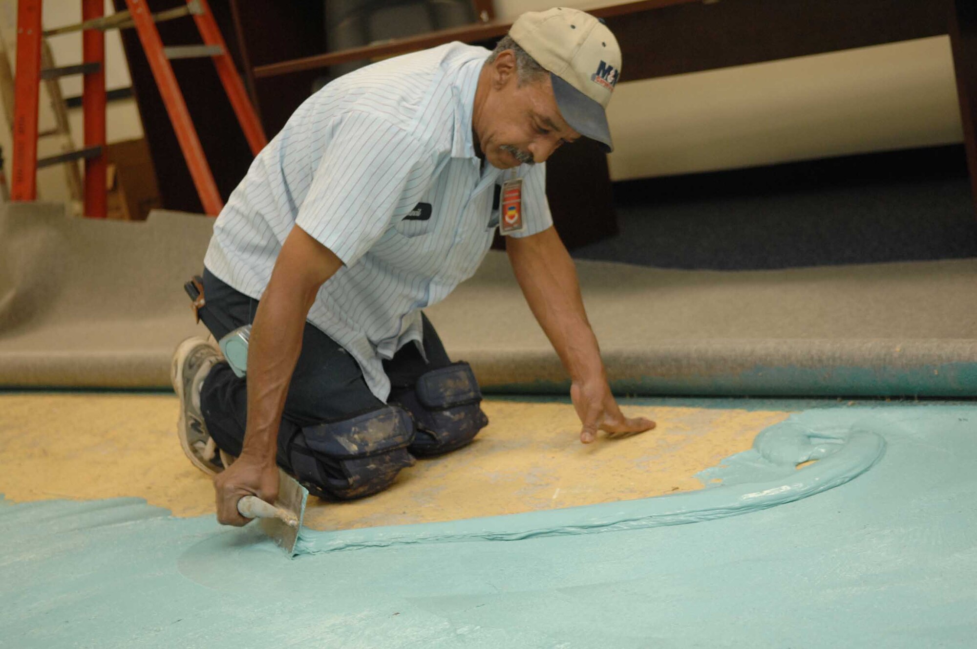 Shaw Air Force Base, S.C. -- John Council, contracted carpet installer, spreads glue as part of the carpet installation in the 20th Fighter Wing Command Post May 15. The new carpet is part of a $1.1 million command post renovation. (U.S. Air Force photo/Staff Sgt. Josef Cole)