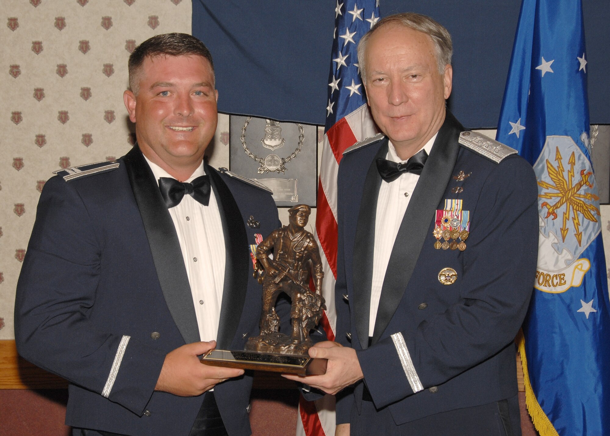 Capt. Johnathan Bennett, 741st Missile Security Forces Squadron, receives the Air Force Space Command Outstanding Security Forces Company Grade Officer of the Year Award from Lt. Gen. Frank Klotz, AFSPC vice commander, during a ceremony at Peterson Air Force Base, Colo., May 10. Captain Bennett was also awarded the Colonel Billy Jack Carter Award that evening. (U.S. Air Force photo / Tech. Sgt. Raheem Moore)
