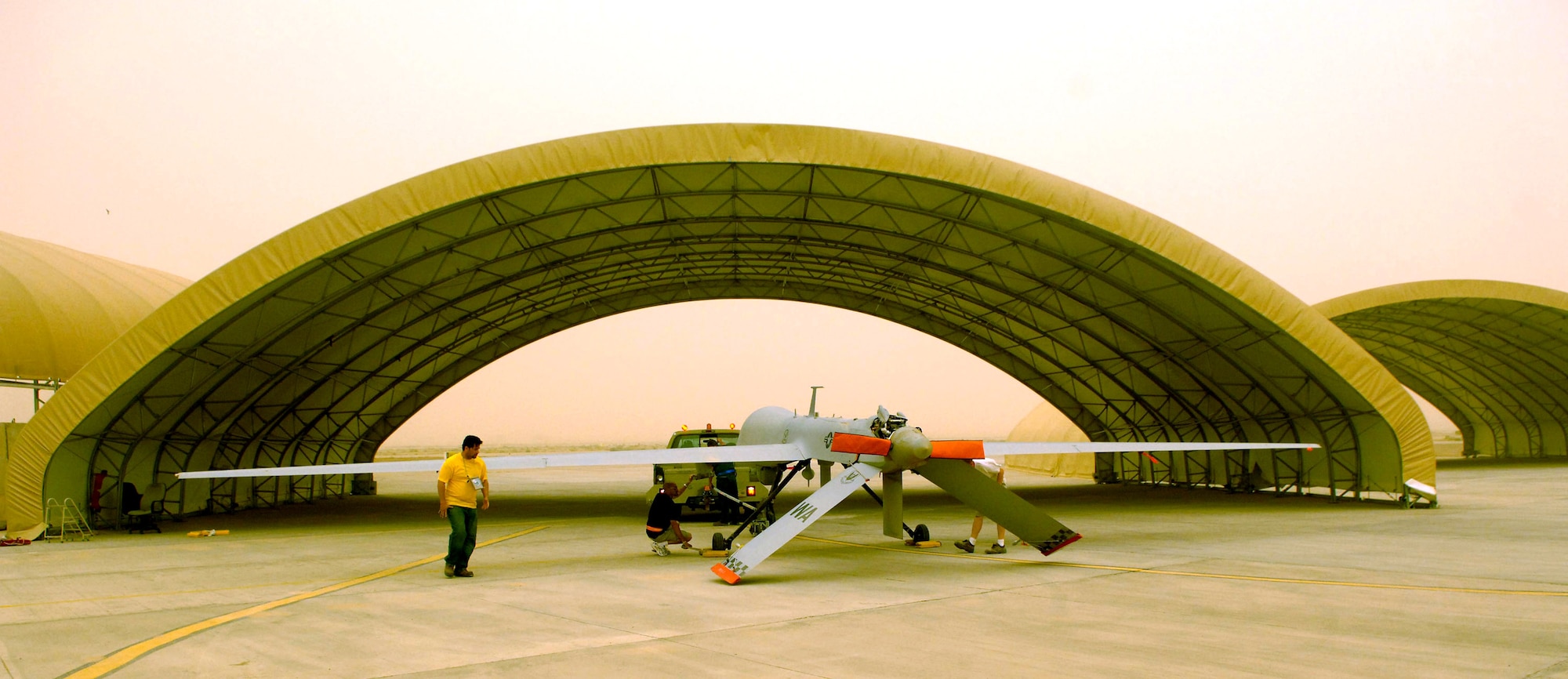 An MQ-1 Predator unmanned aerial vehicle hooks up to be taxied for maintenance after a May 17 mission at Balad Air Base, Iraq. The Predator provides armed reconnaissance, airborne surveillance and target acquisition for coalition forces. The Predator's primary mission is interdiction and conducting armed reconnaissance against critical and perishable targets. (U.S. Air Force photo/Airman 1st Class Jonathan Steffen) 
