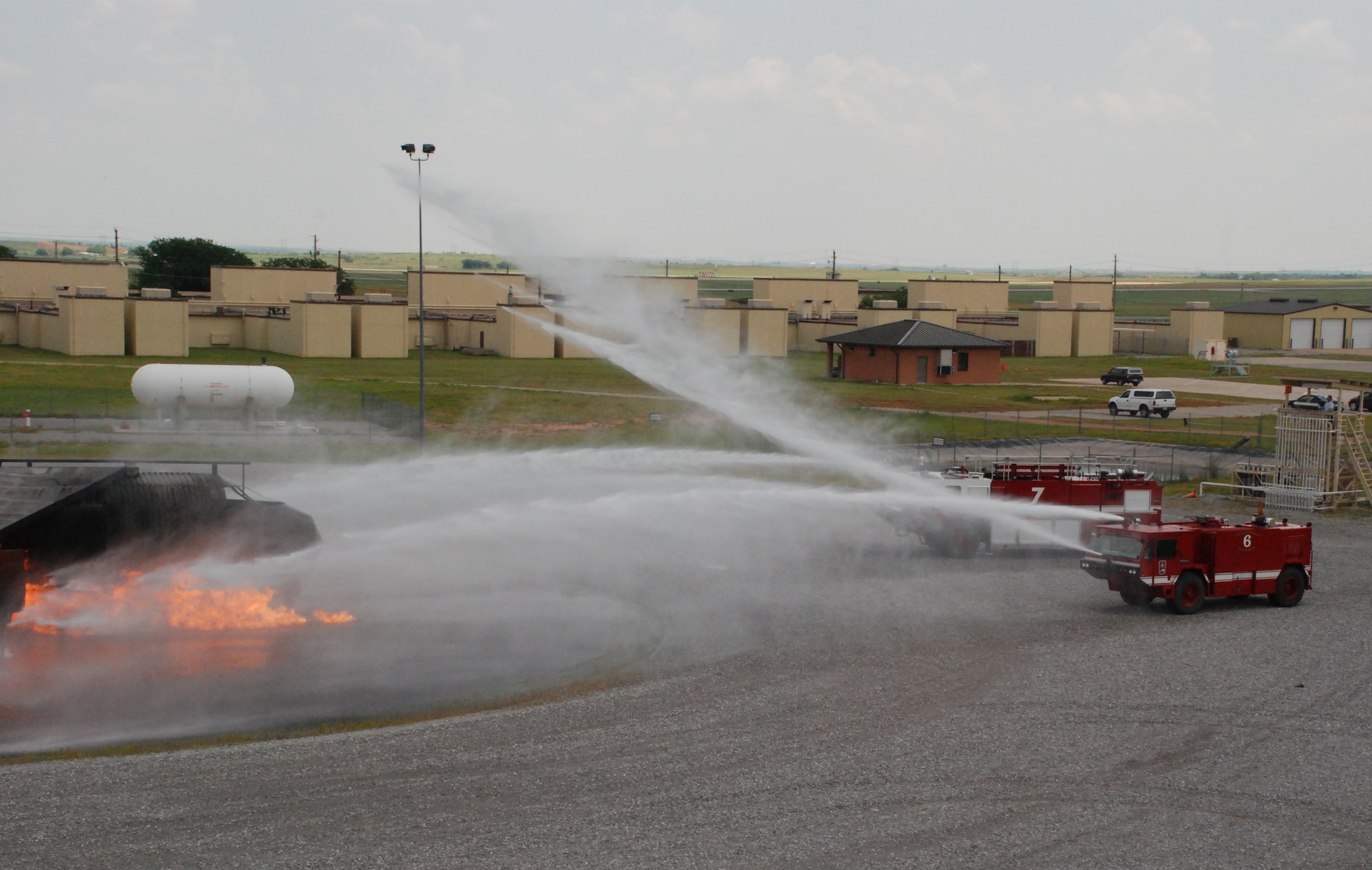Sheppard fire department fire trucks work to douse out a burning airplane during the major accident response exercise May 14. (U.S. Air Force photo/Airman 1st Class Jacob Corbin)