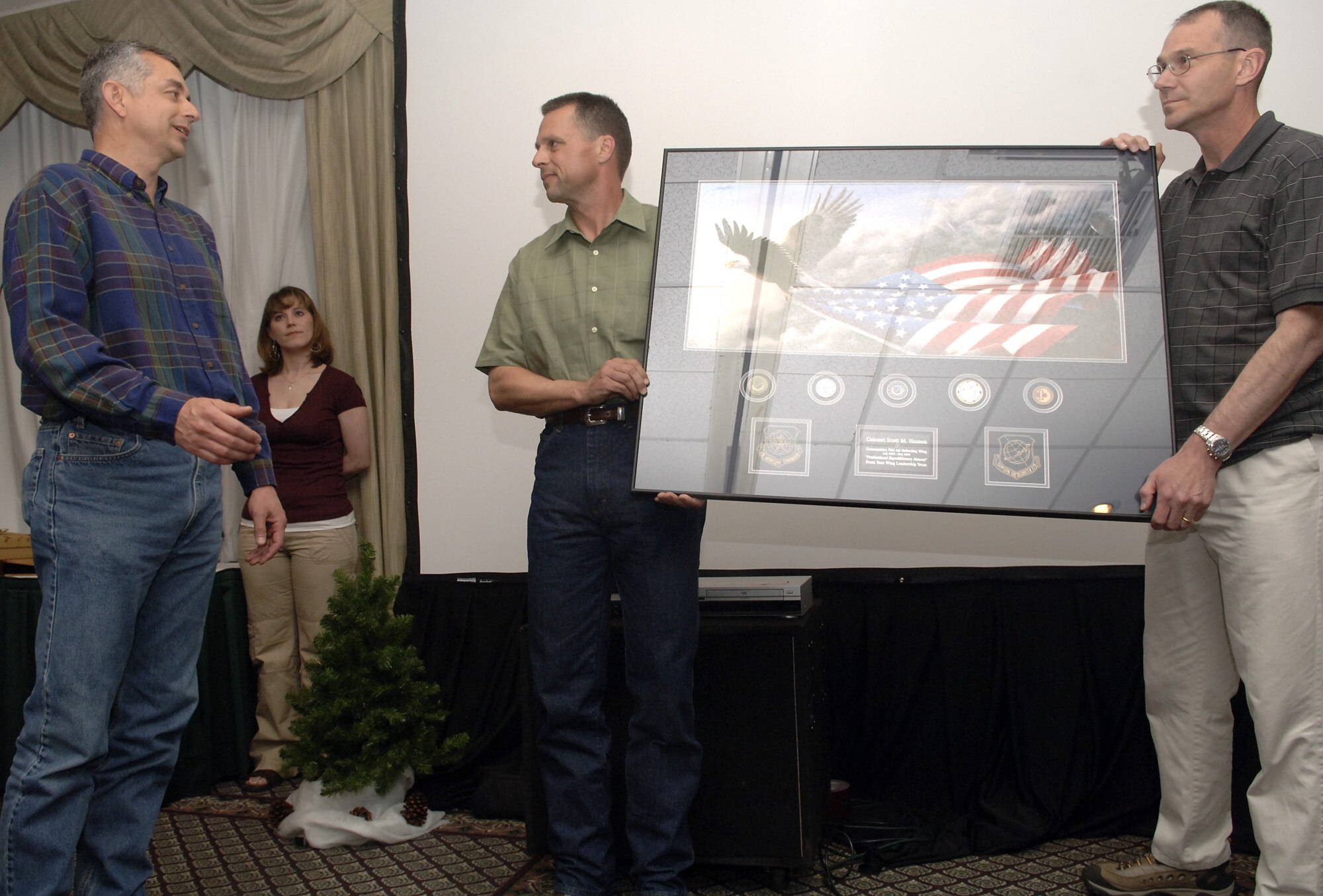 FAIRCHILD AIR FORCE BASE, Wash. -- Col. Roger Watkins, 92nd Air Refueling Wing vice commander, and Col. Mark Melville, 92nd Operations Group commander, present Col. Scott Hansen, 92 ARW commander, with a framed photo as farewell gift from all of the colonels. (U.S. Air Force photo/ Senior Airman Chad Watkins)