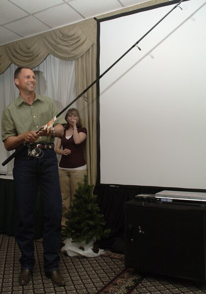 FAIRCHILD AIR FORCE BASE, Wash. -- Col. Scott Hanson, 92nd Air Refueling Wing commander, receives a fishing pole as a parting gift for his tenure at Fairchild on May 15th during his farewell dinner. (U.S. Air Force photo/ Senior Airman Chad Watkins)