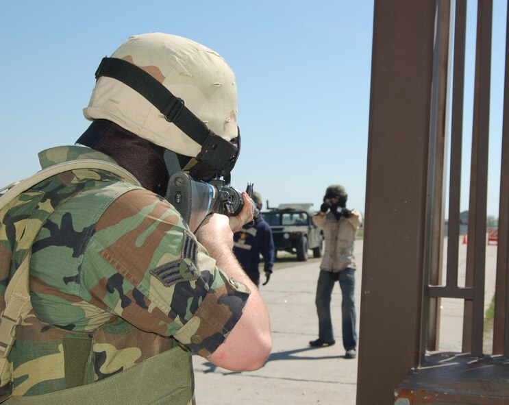 Senior Airman Marcus Wegner, 319th Maintenance Squadron, stops aggressor Airman 1st Class Kevin Boyle, 319th Security Forces training instructor, during the Expeditionary Combat Skills training May 9. (U.S. Air Force photo/Airman 1st Class Ashley Coomes)
