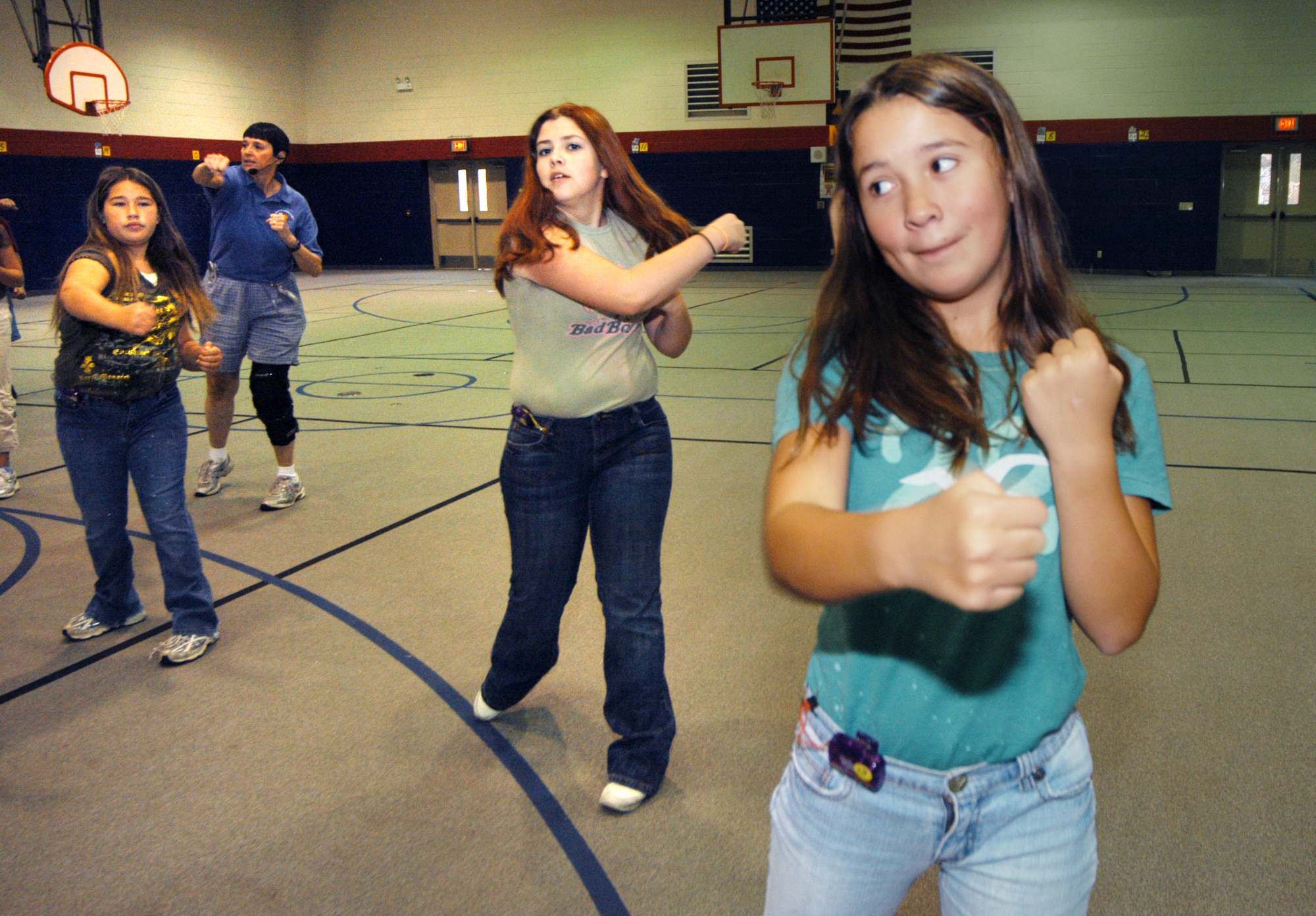 L-R, Chantel Ortiz, Mackenzie Raisanen, and Rebekah Swinford, 6th graders, work out with Deb Hogan, Robins Elementary physical education teacher, to a Tae Bo video designed especially for kids. U. S. Air Force photo by Sue Sapp    