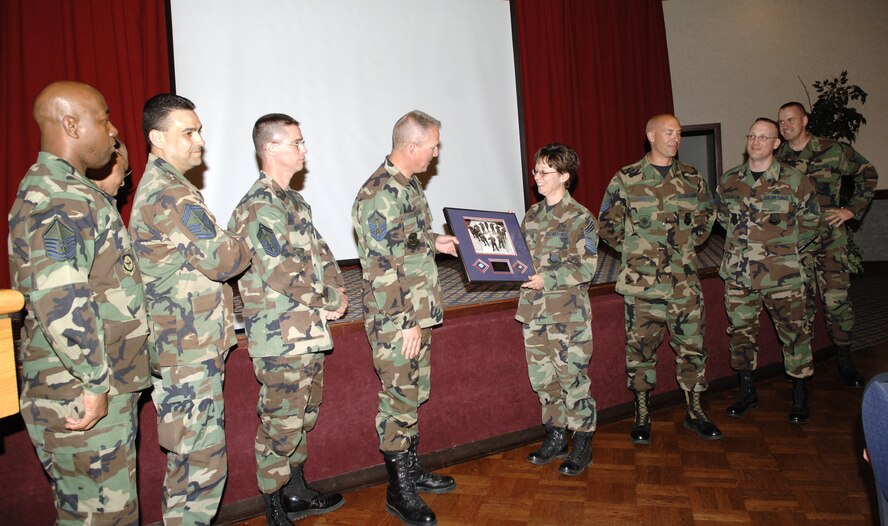 FAIRCHILD AIR FORCE BASE, Wash. -- Chief Master Sgt. Judy Ruiz, 92nd Air Refueling Wing command chief, receives a plaque from Fairchild’s first sergeants during her farewell luncheon May 16 at Club Fairchild. (U.S. Air Force photo/ Airman 1st Class Nancy Hooks) 