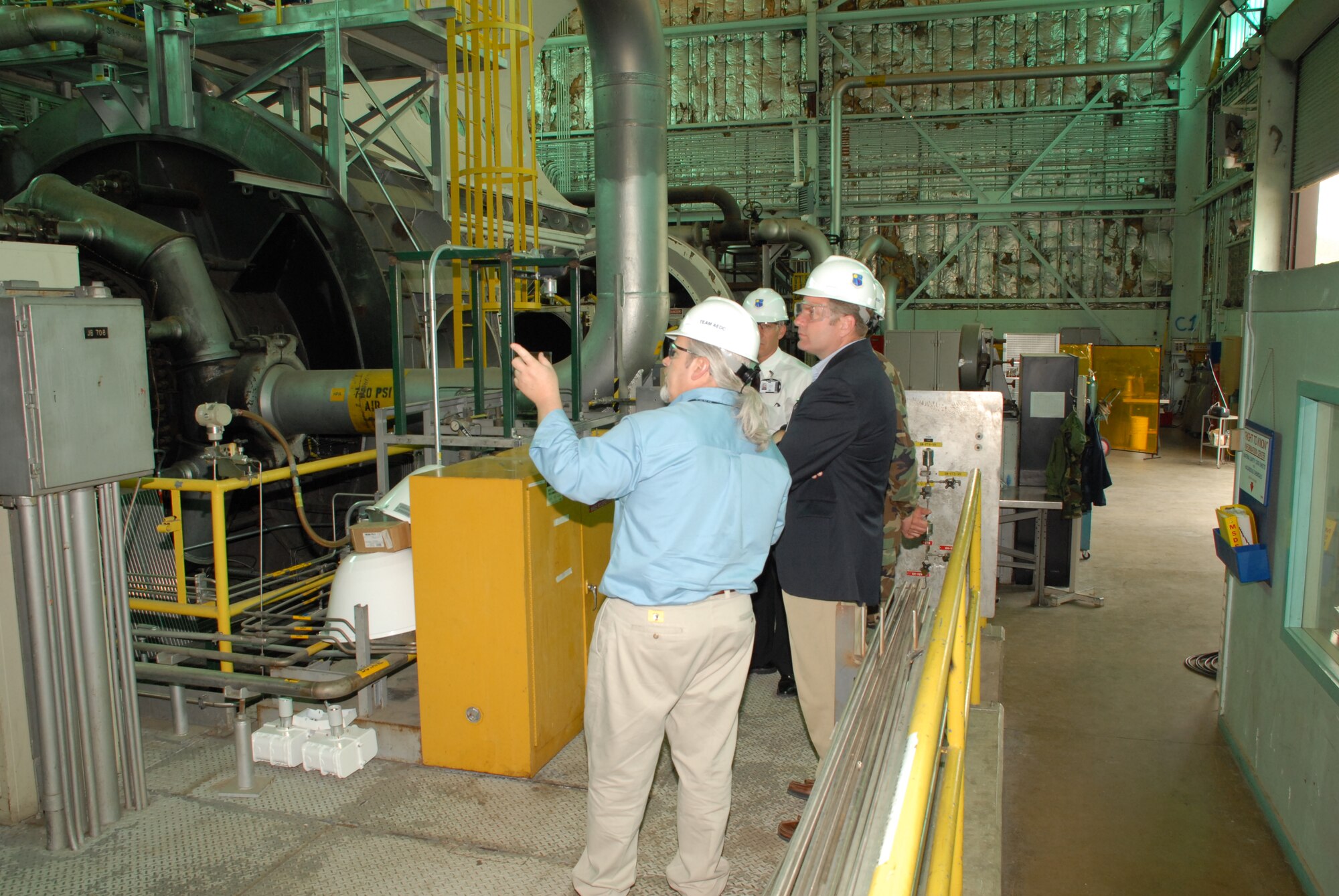 Chris Smith, left, gives an update on upgrades to the Aerodynamic and Propulsion Test Unit to Dr. Steven Walker, who is the Defense Advanced Research Project Agency's Tactical Technical Office deputy director. DARPA is slated to test in the hypersonic test facility once it's fully operational after a multi-million dollar upgrade. (Photo by Rick Goodfriend)