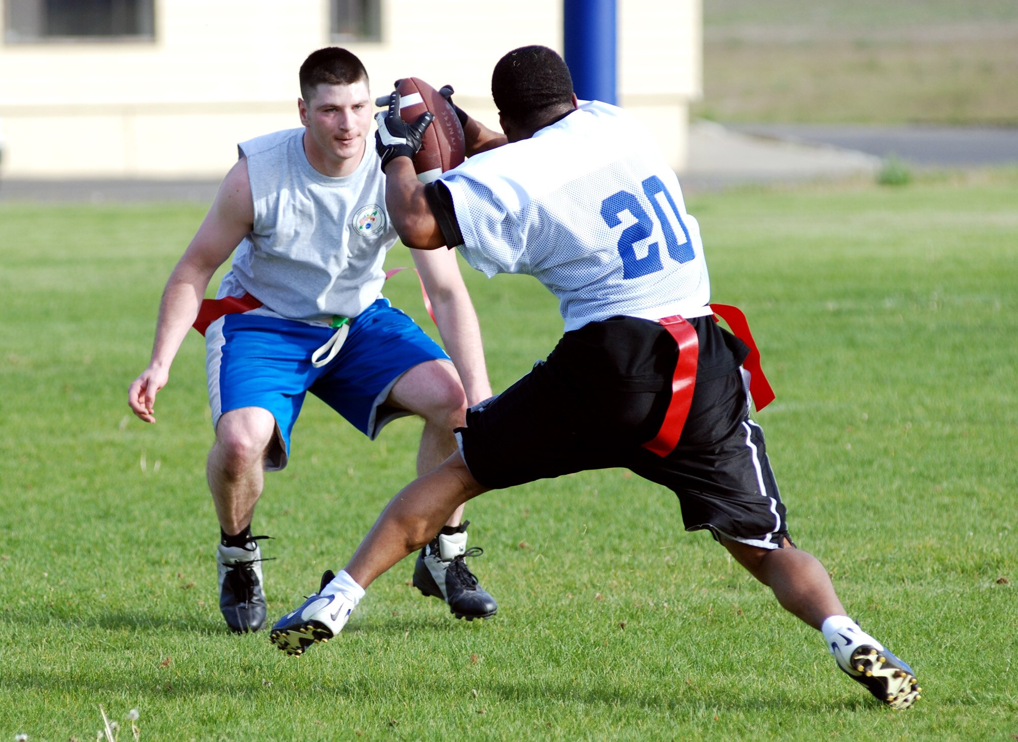 FAIRCHILD AIR FORCE BASE, Wash. -- Senior Airman Michael J. Maffie, 92nd Logistics Readiness Squadron fuels resource controller tries to stop Airman 1st Class Michael A. Nelson , 92nd LRS mobile refueling operator, from scoring a touchdown during practice. The 92nd LRS flag-football team is currently 13-0 and should contend for the base championship this season. (U.S. Air Force Photo/Tech. Sgt. Larry Carpenter