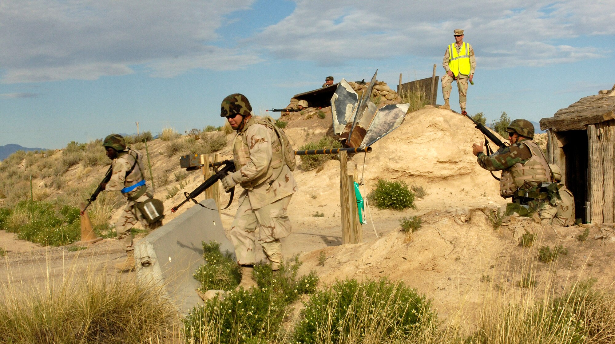 Airmen from the 49th Civil Engineer Squadron charge out of an entry control point during a convoy as part of an exercise at Holloman Air Force Base, N.M., May 7. The civil engineers trained with Soldiers from Fort Bliss, Texas, to incorporate the total force scenario experience. (U.S. Air Force photo/Airman 1st Class Michael Means) 