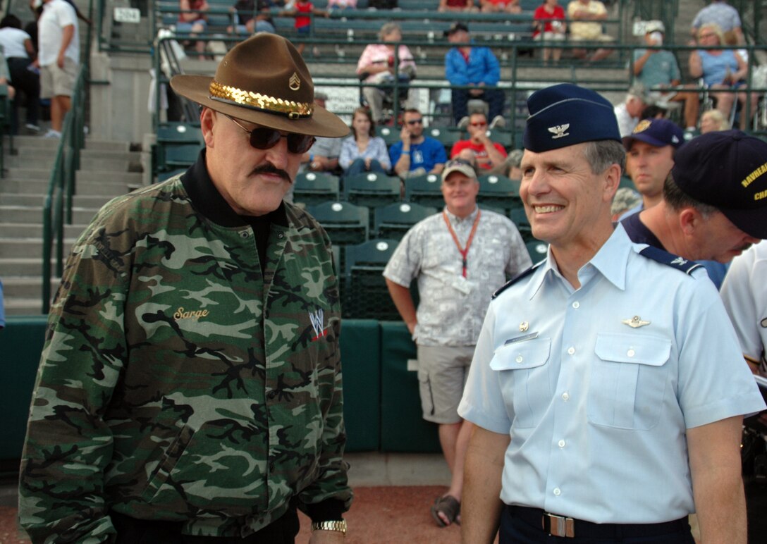 Col. Tim Wrighton, commander of the 315th Airlift Wing at Charleston AFB, S.C., talks to Sergeant Slaughter, WWE Wrestling Superstar, while the pair gets ready to throw out the first pitch at the River Dogs' military appreciation night. (Photo by Capt. Wayne Capps, USAFR)