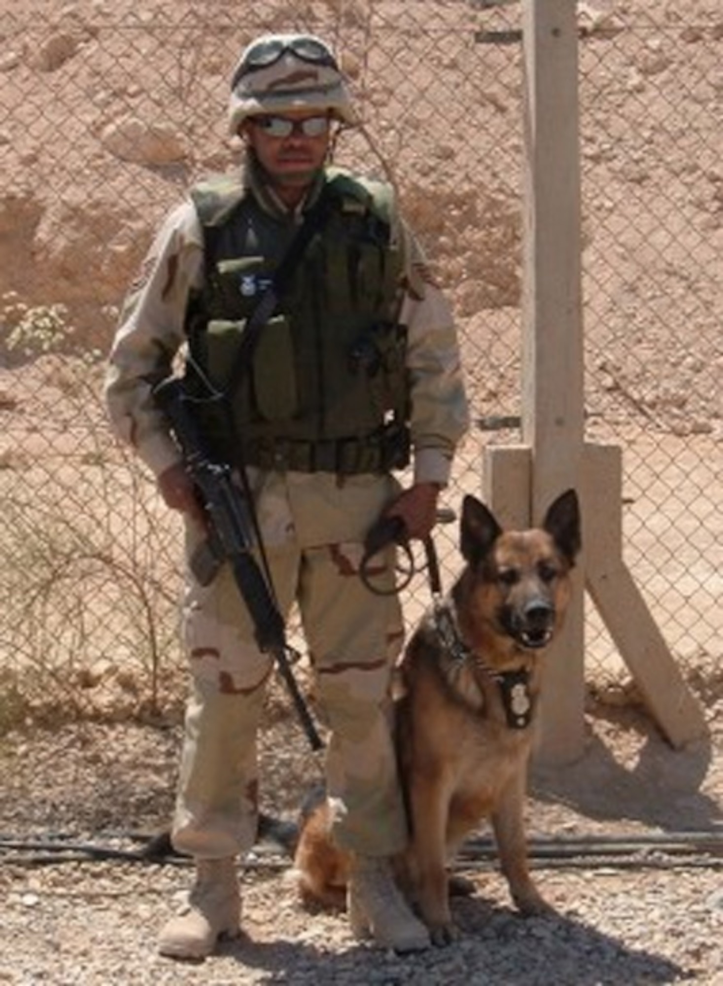 SPANGDAHLEM AIR BASE, GERMANY -- Members of the 52nd Security Forces Squadron mourn the lost of military working dog, Alan, who was put down with his handler by his side May 14. Alan suffered from Degenerative Myelopathy of his spine an autoimmune disease where the canine's immune system attacks their central nervous system. Alan, a German Shepherd, was accepted into the Air Force in Sept. 1999. He was one of the first MWD’s to serve in Iraq at the start of the war and was featured on an episode of Animal Planet. Alan is pictured above with his handler then Staff Sgt. Cleophus Gallon during May 2004 in Fallujah, Iraq. Alan was forever faithful and served with honor. (US Air Force photo)

