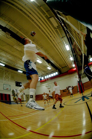 EGLIN AIR FORCE BASE, Fla. -- Jacob Allen, 33rd Fighter Wing, takes a pass from Jamie Cummins and pounds it to the floor of the 96th Civil Engineer Group during the intramural volleyball championships here May 16. The 33rd FW doubly eliminated the 96th in a best-of-three match game, 19-25, 25-18 and 15-7 to win their third intramural volleyball championship in a row. (U.S. Air Force photo by Staff Sgt. Mike Meares)
