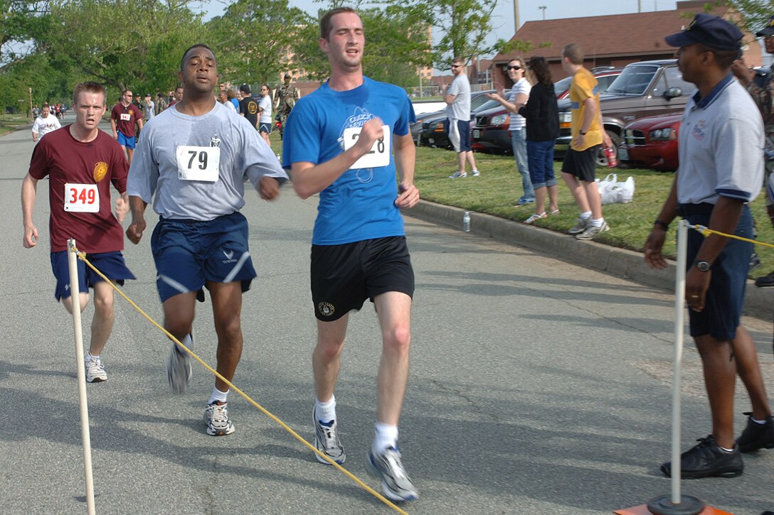 Leading from the front is Airman Pingree Zachary, from the 27 Intelligence Squadron, follows by Lieutenant Colonel Andrews Keith, from the 10 Intelligence Squadron, and after him is Airman Small Travis, from the 27 Intelligence Squadron race toward the finish line during the 5K run on May 11, 2007 at at Little League Field Across from Enlisted Club, Langley AFB, VA.  The 5K run/walk is encouraging Air Force members to participate in order to raise fun and promote physical fitness. (U.S. Air Force photo by A1C Nguyen)


