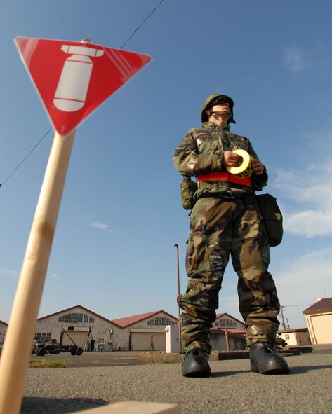 Airman 1st Class Matthew Lopez prepares to set up a cordon for an unexploded ordnance discovered buringa sweep. (Photo by Airman 1st Class Laszlo Bobocsi VIRIN 070507-F-8519B-022)