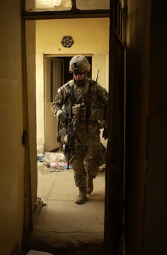 U.S. Army Sgt. Joshua Roelle searches an abandoned house during a cordon and search in Ameriyah, Iraq, on May 14, 2007.  Roelle is assigned to 1st Battalion, 23rd Infantry Regiment, 3rd Stryker Brigade Combat Team.  