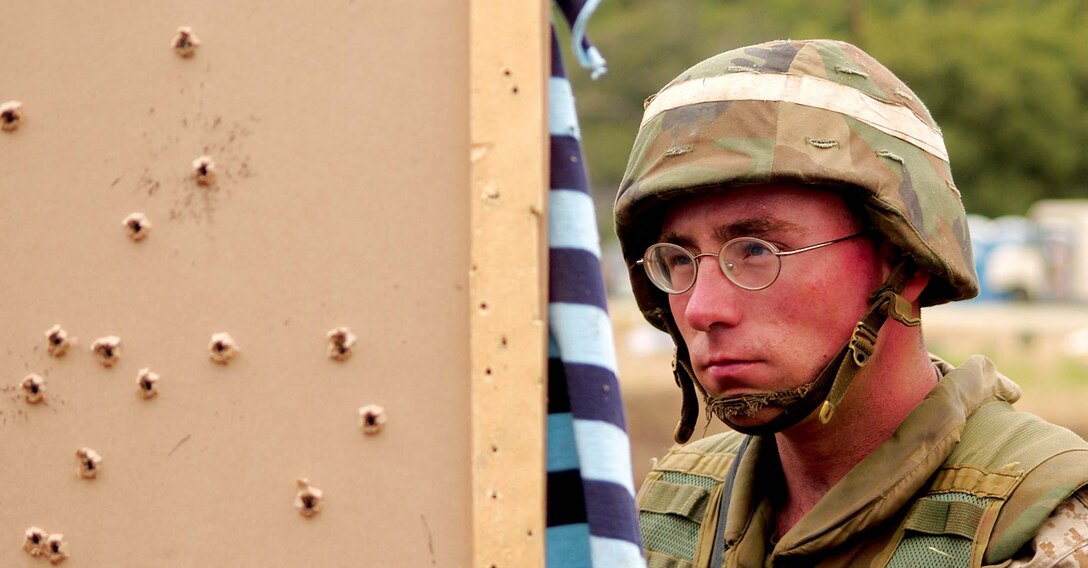 Cpl. Roy A. Foster, a reservist with Battery L, 4th Battalion, 14th Marine Regiment in Bessemer, Ala., observes the product of his work with the M16A2. Targets were dressed up as humans to simulate human threats