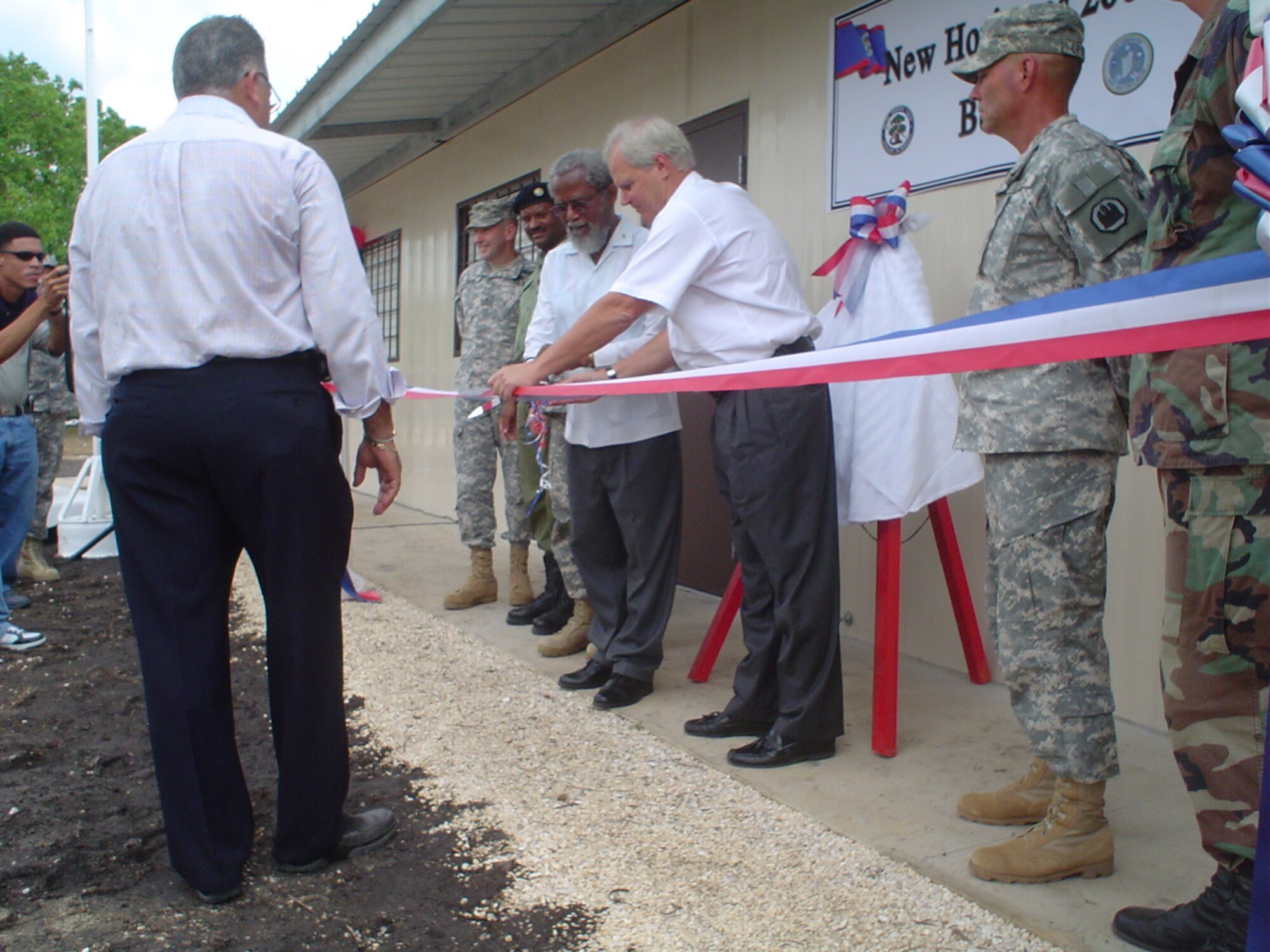 Ceremony officials cut the ribbon at the New Horizons 2007 Belize closing ceremony in Hattiesville, Belize, May 18.  This two-room school is one of four schools built by U.S. and Belizean Defense Forces personnel.  U.S. Air Force photo by Capt. Alysia Harvey