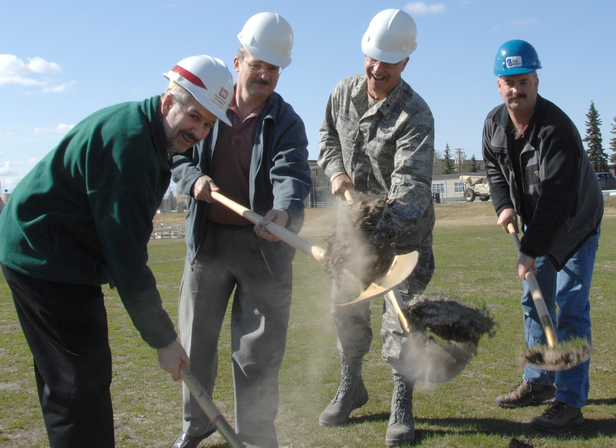 EIELSON AIR FORCE BASE, Alaska -- 354th Fighter Wing Commander, Brig. Gen. David Scott, members of the ALCAN General, and Army Corp of Engineers break ground on the 354th Services Squadrons Baker Field House addition during a ceremony May 18 at the future location of the $24 million, 60,000 sq. ft. facility. The addition includes an indoor playing field allowing for intramural play of flag football and soccer, a 1/8 mile running track enabling year-round Air Force Fitness Management testing, and a weight-room. The fitness center renovation project emphasizes the high priority the Air Force places on health and wellness.  The addition is scheduled to be complete by July 2008.  (U.S. Air Force photo by Staff Sgt. Tia Schroeder)