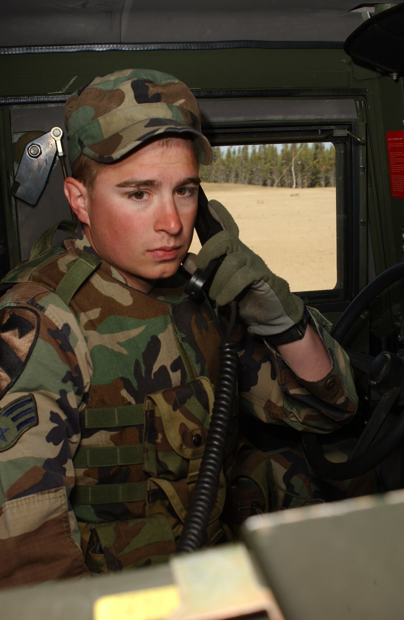 EIELSON AIR FORCE BASE, Alaska -- Senior Airman Robert Olson, 3rd Air Support Operations Squadron tactical air control party, uses a Radio Set Control to speak with another Humvee in the convoy during Operation URSA Minor, May 17 on the Pacific Alaska Range Complex. The last scenario of the exercise 3rd ASOS Airmen must use all their navigational skills to transport an Air Liaison Officer to checkpoint two avoiding possible improvised explosive devices along the way. (U.S. Air Force Photo by Airman 1st Class Jonathan Snyder) 