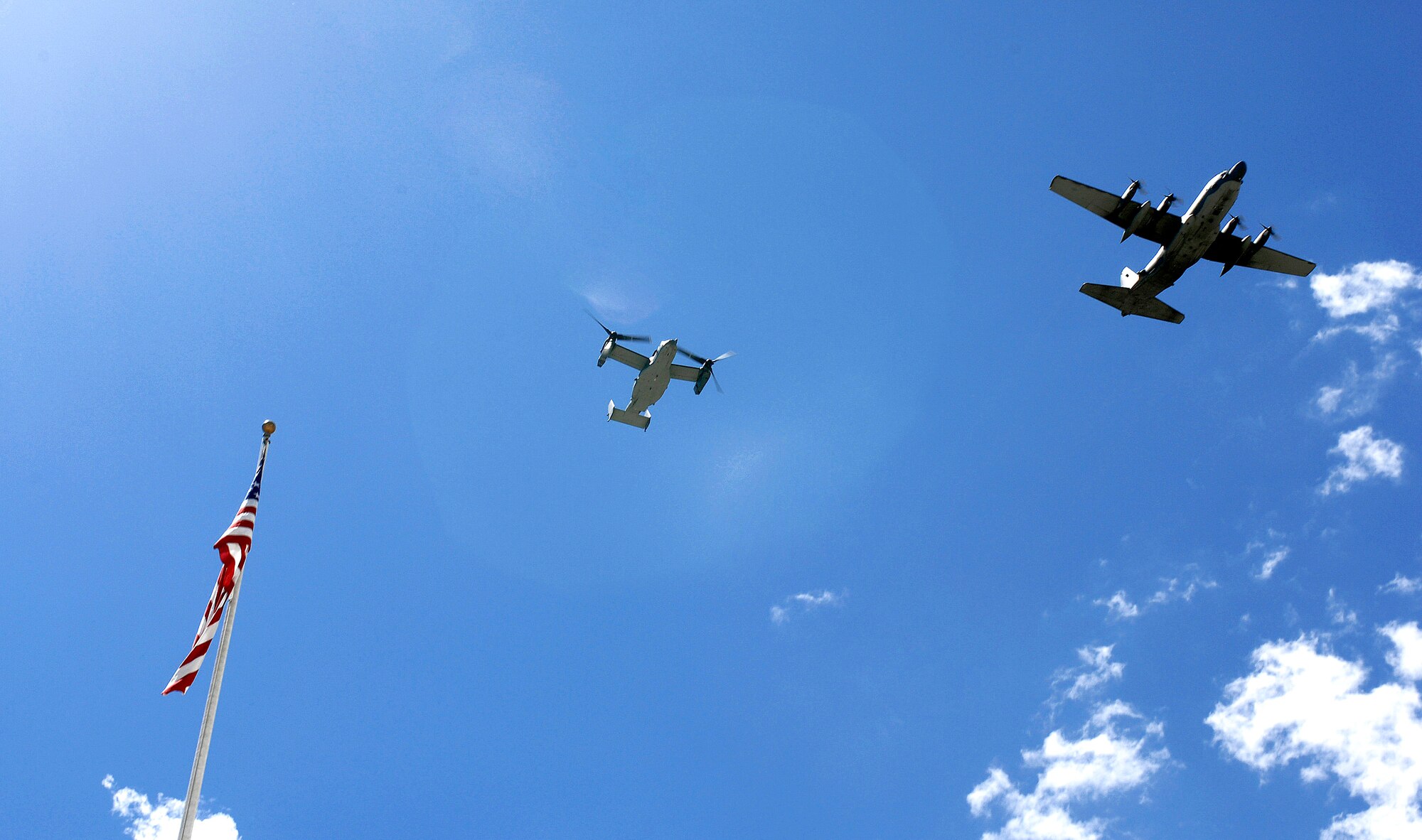 A CV-22 Osprey trails a C-130 Hercules as they fly over the U.S. Air Force Academy May 11.  Cadets in the Department of Aeronautical Engineering's High-Performance Computing Research Center contributed to making this aircraft an operational reality through their research in computational fluid dynamics.  (U.S. Air Force photo/ Dennis Rogers)