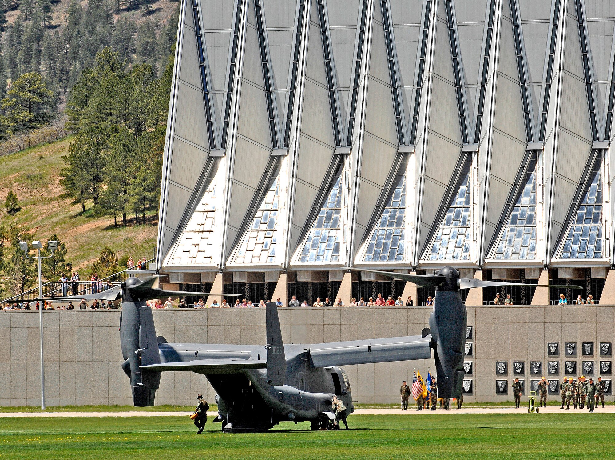 Cadets and active-duty troops get a close look at a CV-22 Osprey after it landed at the U.S. Air Force Academy May 11. Cadets in the Department of Aeronautical Engineering's High-Performance Computing Research Center contributed to making this aircraft an operational reality through their research in computational fluid dynamics. The famed Academy chapel is in the background. (U.S. Air Force photo/ Dennis Rogers)
