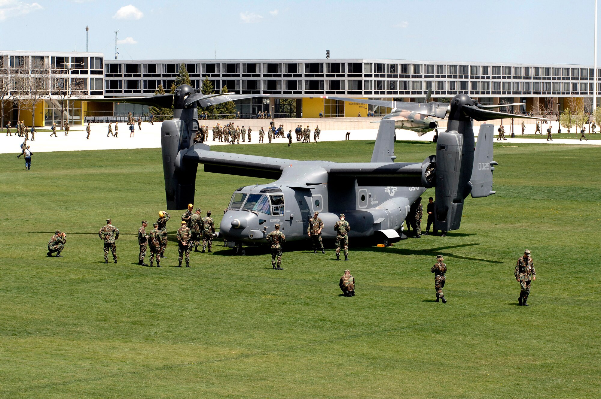 Cadets and active-duty troops swarm around a CV-22 Osprey after it landed at the U.S. Air Force Academy May 11. Cadets in the Department of Aeronautical Engineering's High-Performance Computing Research Center contributed to making this aircraft an operational reality through their research in computational fluid dynamics.  (U.S. Air Force photo/ Dennis Rogers)