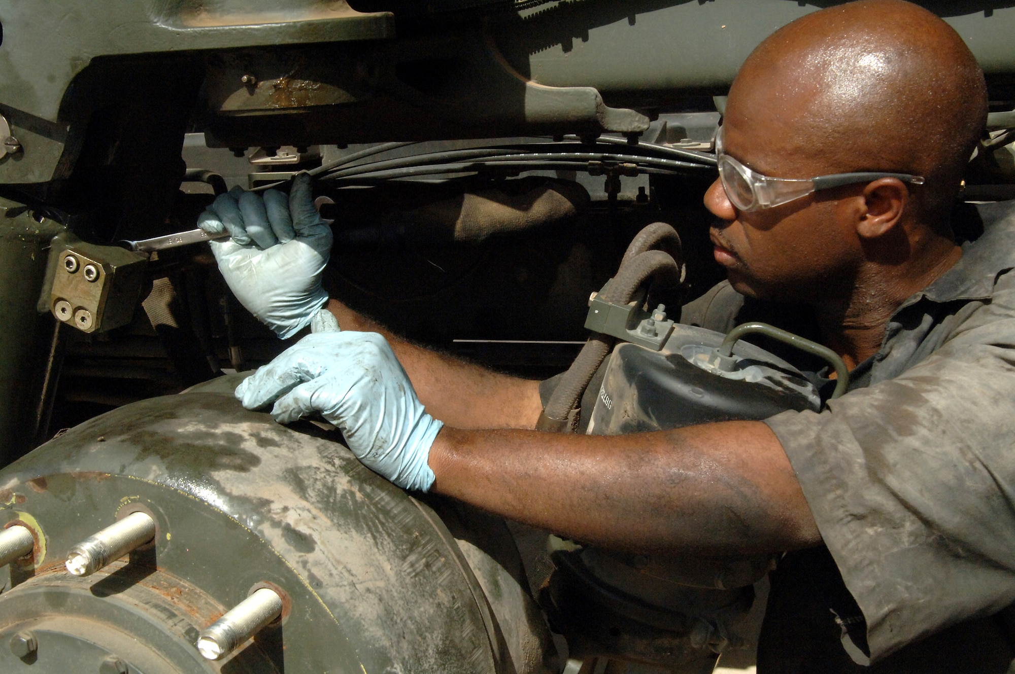 Staff Sgt. Dwain Waldo replaces the hydraulic suspension cylinder on a 60-K loader April 25 at Balad Air Base, Iraq. Sergeant Waldo is a 332nd Expeditionary Logistics Readiness Squadron material handling equipment mechanic deployed from Minot Air Force Base, N.D. (U.S. Air Force photo/Senior Airman Candace Romano)