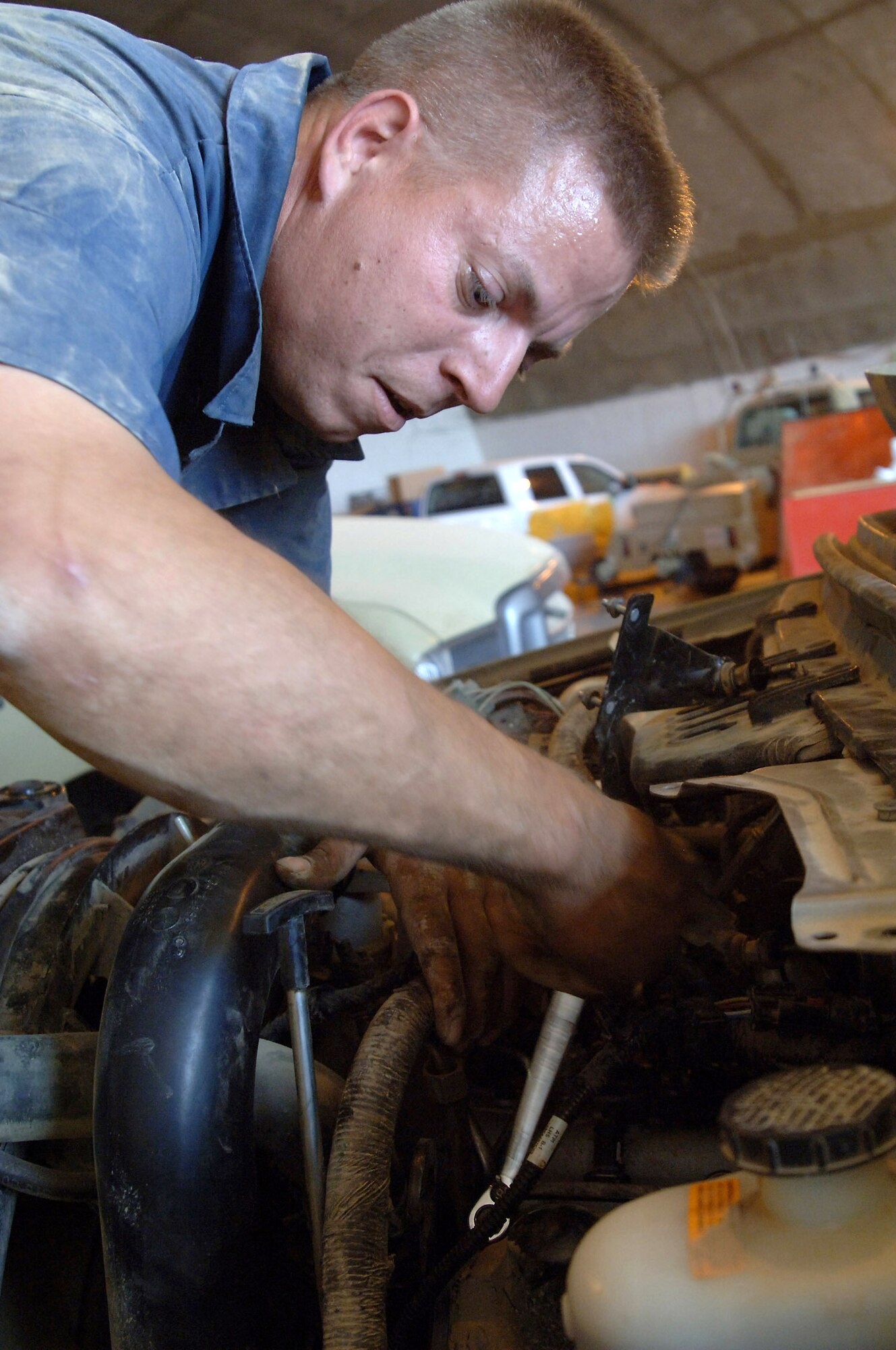 Staff Sgt. Timothy Lewis removes the valve cover off of the engine of a flightline tow truck April 25 at Balad Air Base, Iraq. Sergeant Lewis is a vehicle maintenance technician with the 332nd Expeditionary Logistics Readiness Squadron deployed from Minot Air Force Base, N.D. (U.S. Air Force photo/Senior Airman Candace Romano)