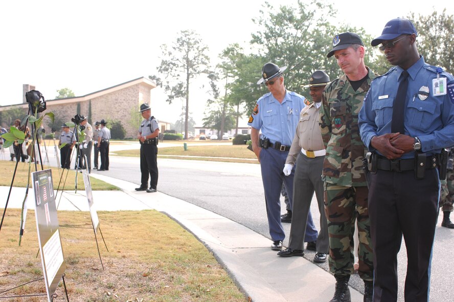 Moody security forces Airmen join policemen from Lowndes County, Valdosta, and the Georgia State Patrol to pay tribute to officers who were killed in action during  Police Week Memorial Ceremony May 15. Moody's Police Week featured several events, including the memorial and a golf tournament, to recognize the efforts of policemen. (U.S. Air Force photo by Senior Airman Angelita M. Lawrence)
