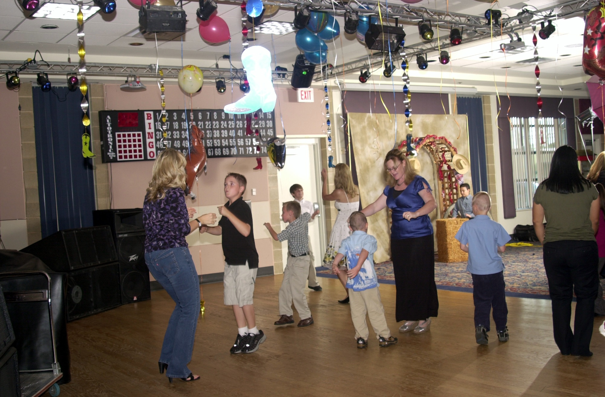 Moms and sons boogie on down by dancing the “Twist” during the Annual Mother/Son Dance. (U.S. Air Force photo by Airman 1st Class Luis Loza Gutierrez)