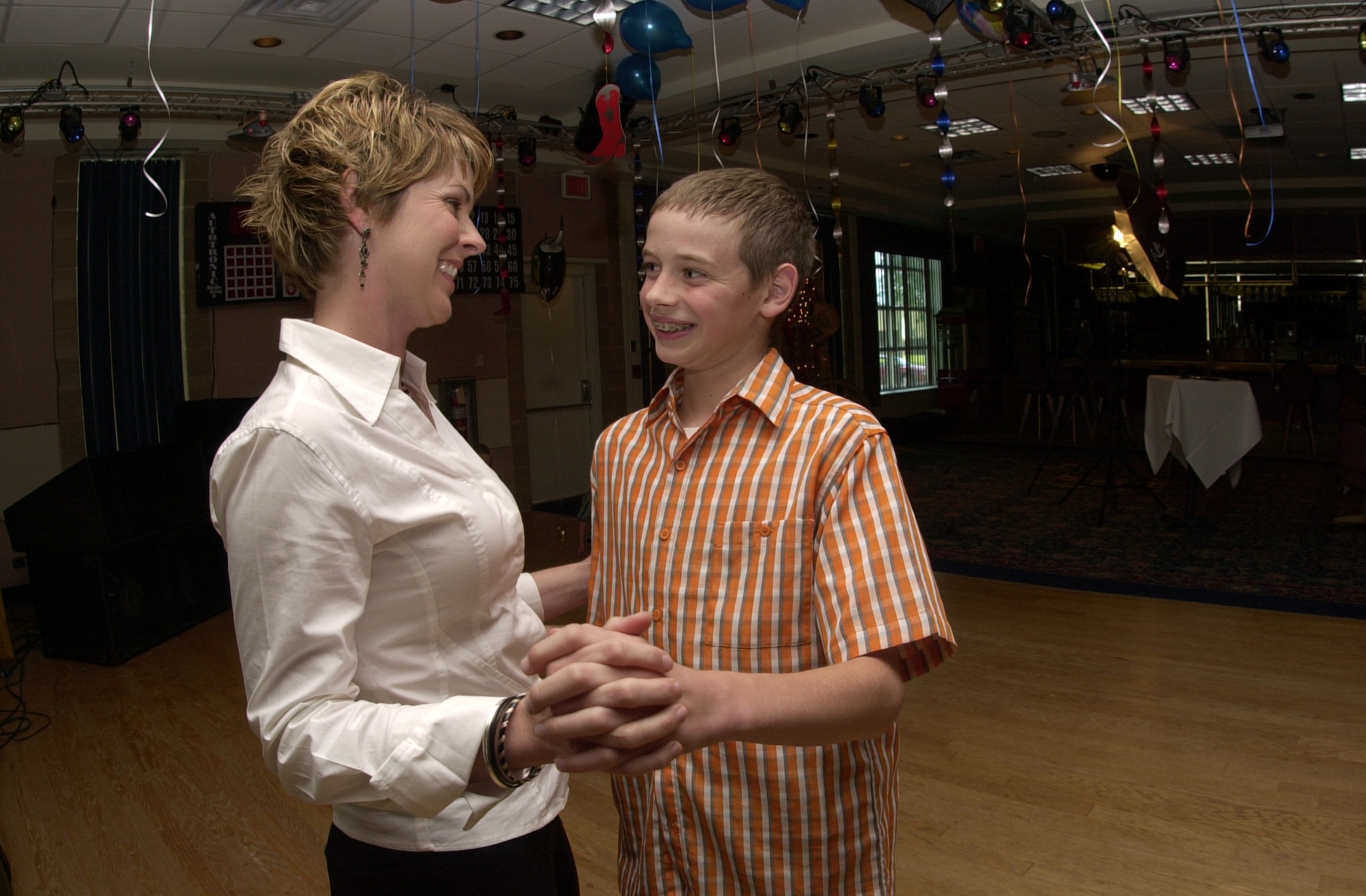 Jan Menard and her 12-year-old son Zachary Fair exchange smiles as they enjoy dancing to some slow country music during the Annual Mother/Son Dance held May 10 at the Goodfellow Events Center. (U.S. Air Force photo by Airman 1st Class Luis Loza Gutierrez)