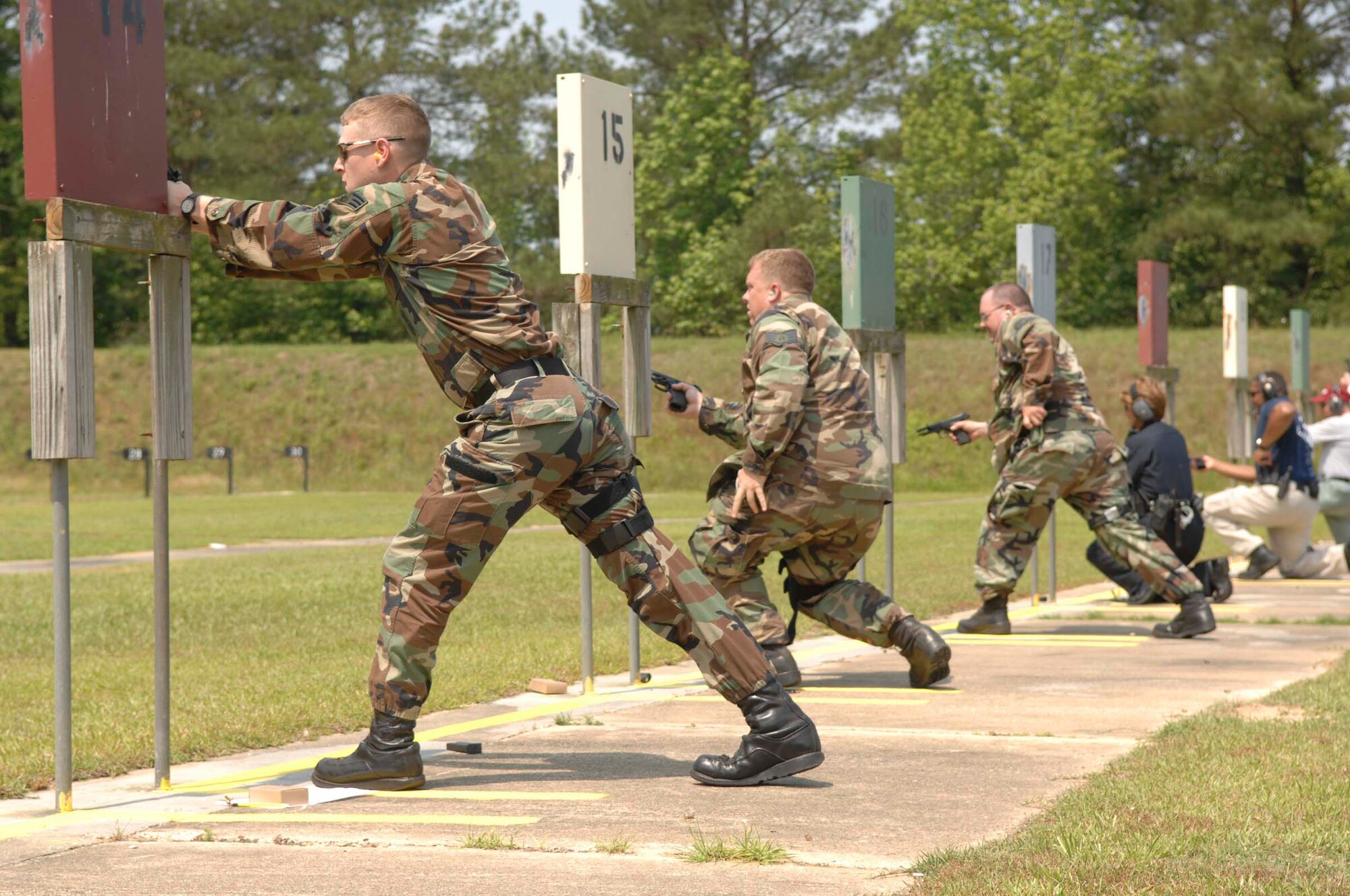 SUMTER, S.C.-- Senior Airman Tommy Dailey, Staff Sgt. Edward Lincoln and Staff Sgt. Richard Dorsey, 20th Security Forces Squadron and local law enforcement members participate in friendly competition at the Sumter Police Department firing range May 16. During the week, on and off-base events included city and county police and 20th Security Forces Squadron members. The theme for each of the events was remembering those who made the ultimate sacrifice. (U.S. Air Force photo/Airman 1st Class Matthew Davis)
