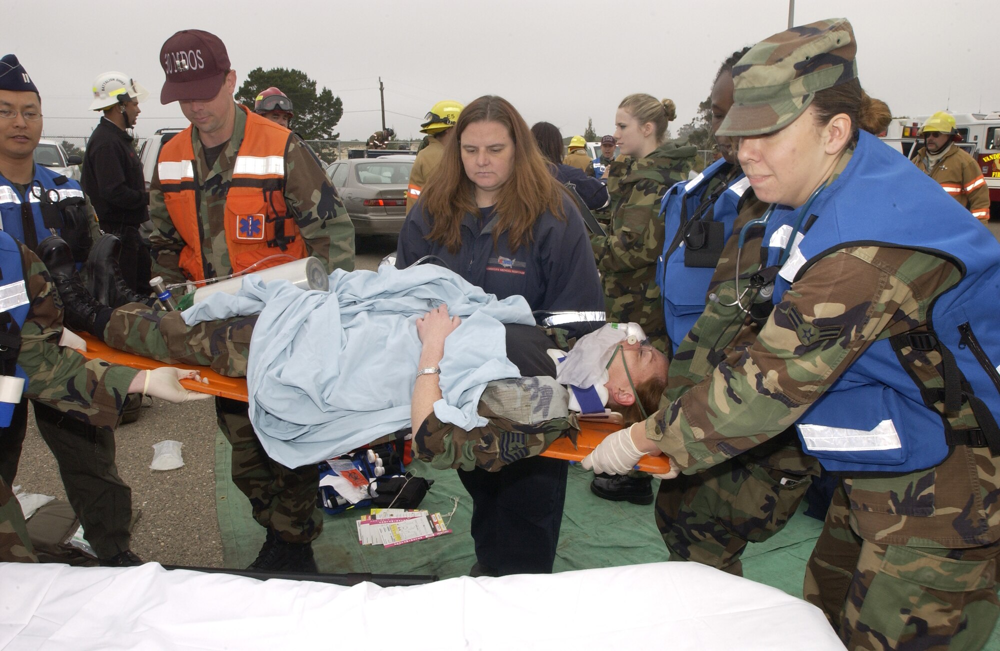 During the first day of the Foggy Shores exercise, 30th Medical Operations Squadron Airmen transport Tech. Sgt Suzanne Bell, 30th MDOS, as she simulates an injury. A simulated earthquake partially collapsed Bldg. 8500, trapping many people inside as part of a Foggy Shores exercise at Vandenberg Air Force Base on May 14 to 15. (U.S. Air Force Photo by Staff Sgt Angelique Perez)