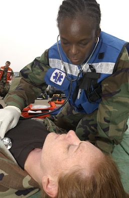 On the first day of the Foggy Shores exercise, Capt. Mary Creswell checks the vital signs on Tech. Sgt. Suzanne Bell as she simulates an injury on May 14. Both Airmen from the 30th Medical Operations Squadron participated in the earthquake simulation of a partially collapsed building that trapped many people inside at Vandenberg Air Force Base . (U.S. Air Force Photo by Staff Sgt Angelique M. Perez)