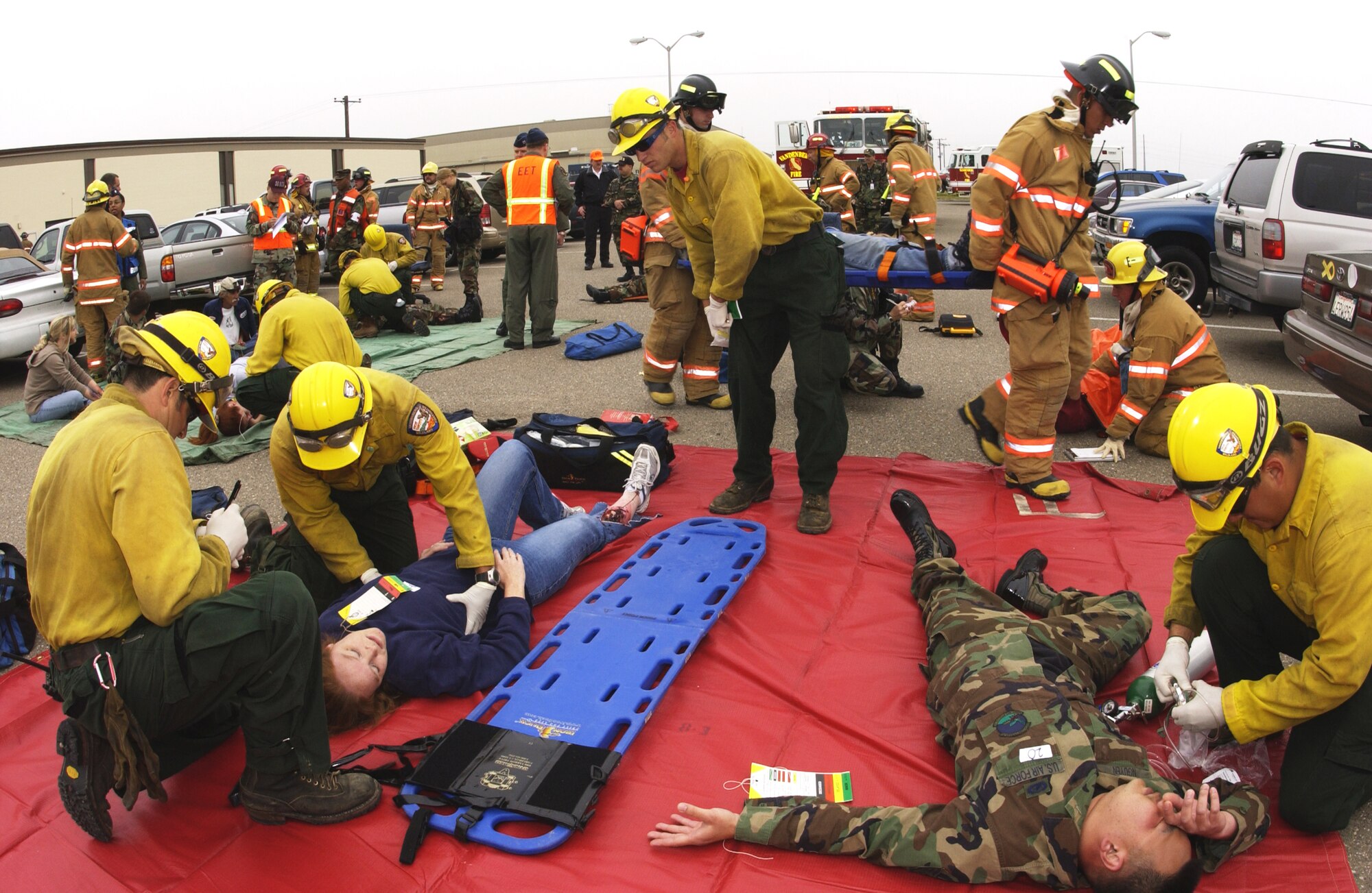 On the first day of the Foggy Shores exercise, firefighters and Hot Shots treat simulated victims of an earthquakeat Bldg. 8500 on May 14. The two-day exercise tested the readiness of Vandenberg Air Force Base personnel in the event of a disaster or threat. (U.S. Air Force photo by Airman 1st Class Christian Thomas) 